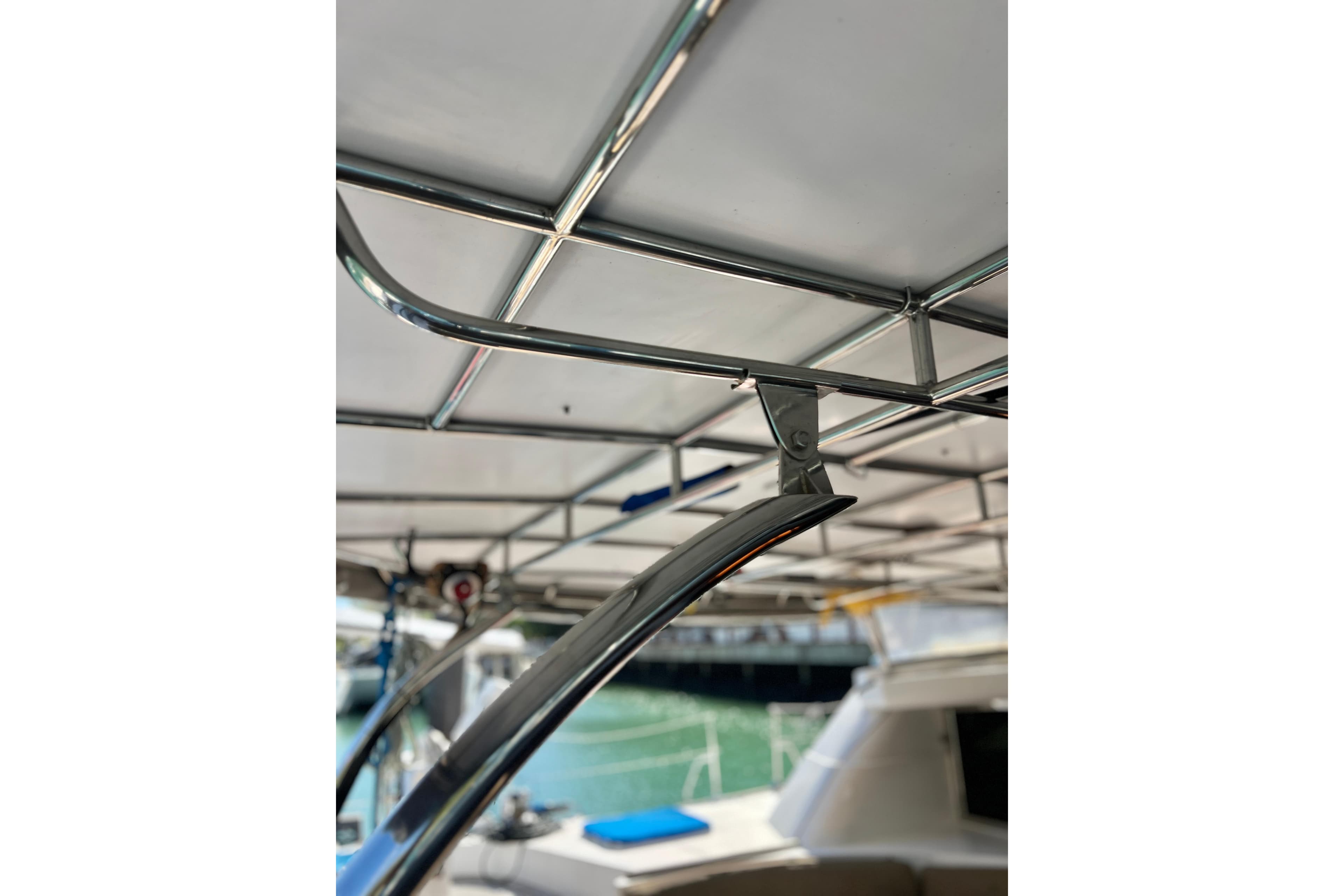 Stainless steel framework on Concordia Dickson 69 yacht, 2005 model, with marina background.