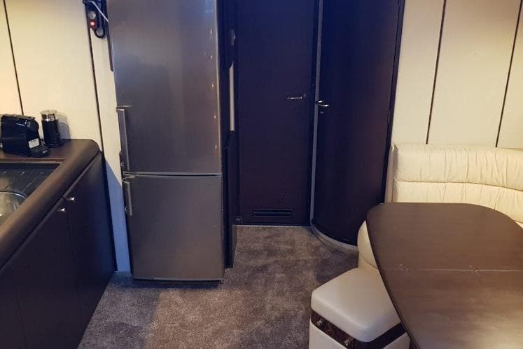Interior of a 1996 Princess V52 yacht with modern kitchen and dining area.