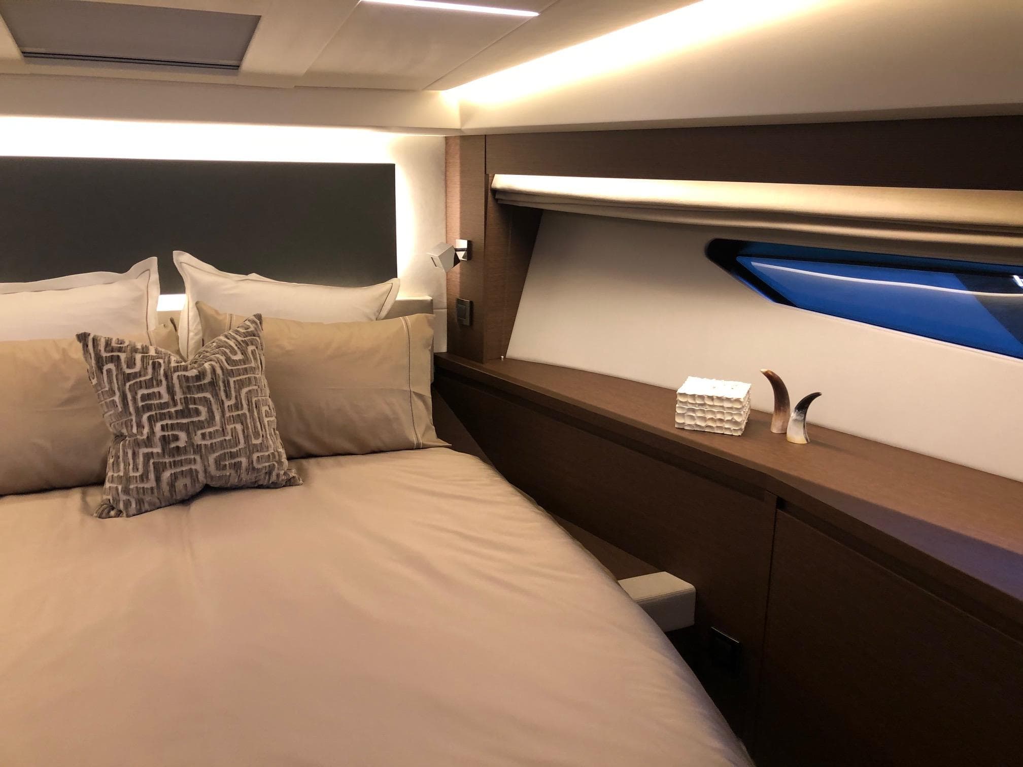 Luxurious bedroom interior of 2024 Prestige 520 Flybridge yacht with elegant bedding and decor.