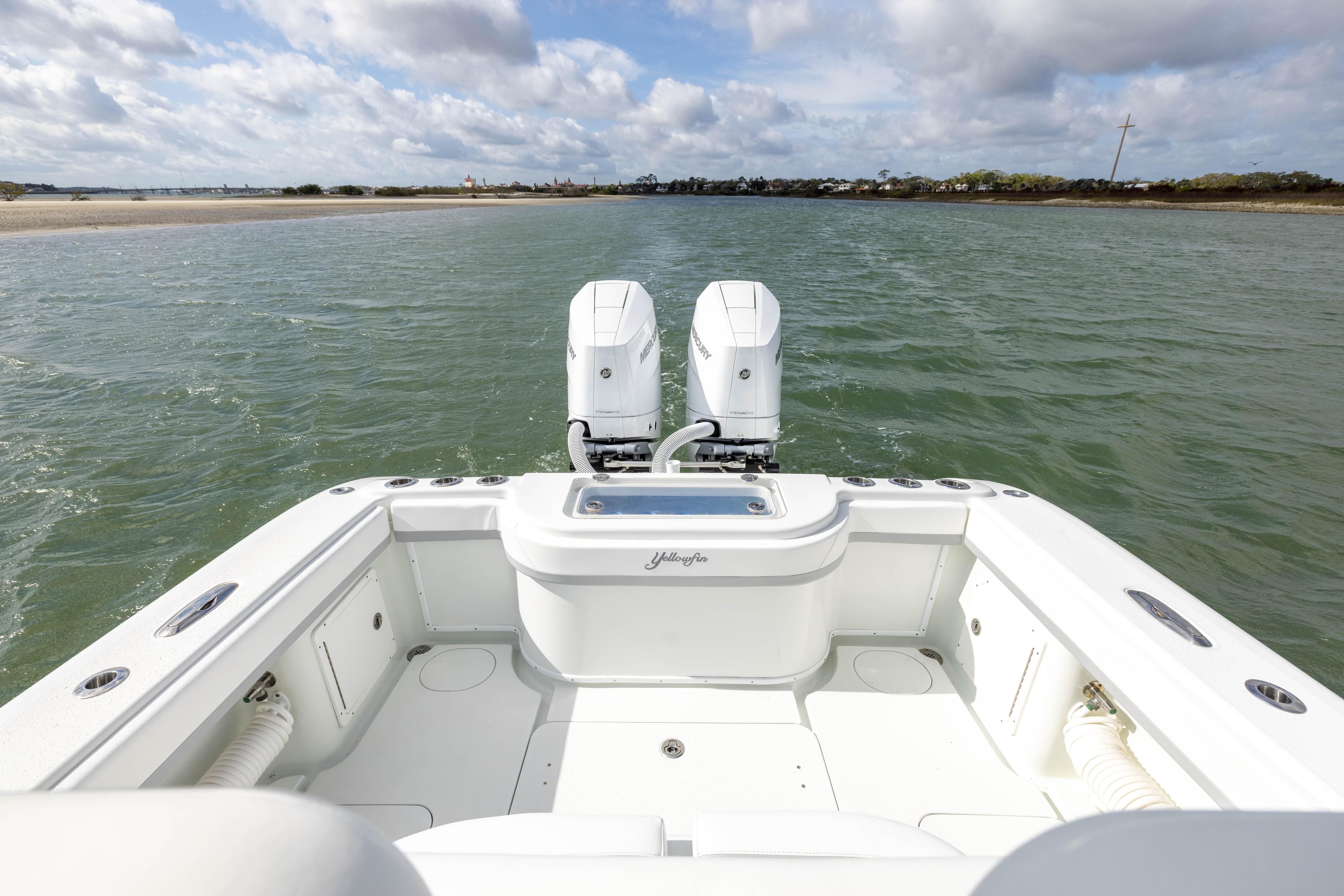 2014 Yellowfin 32 Offshore boat on water, featuring dual engines and spacious deck.
