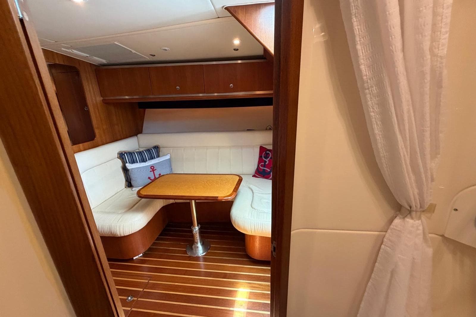 2007 Tiara Yachts 3600 Open cabin interior with cozy seating and wooden accents.