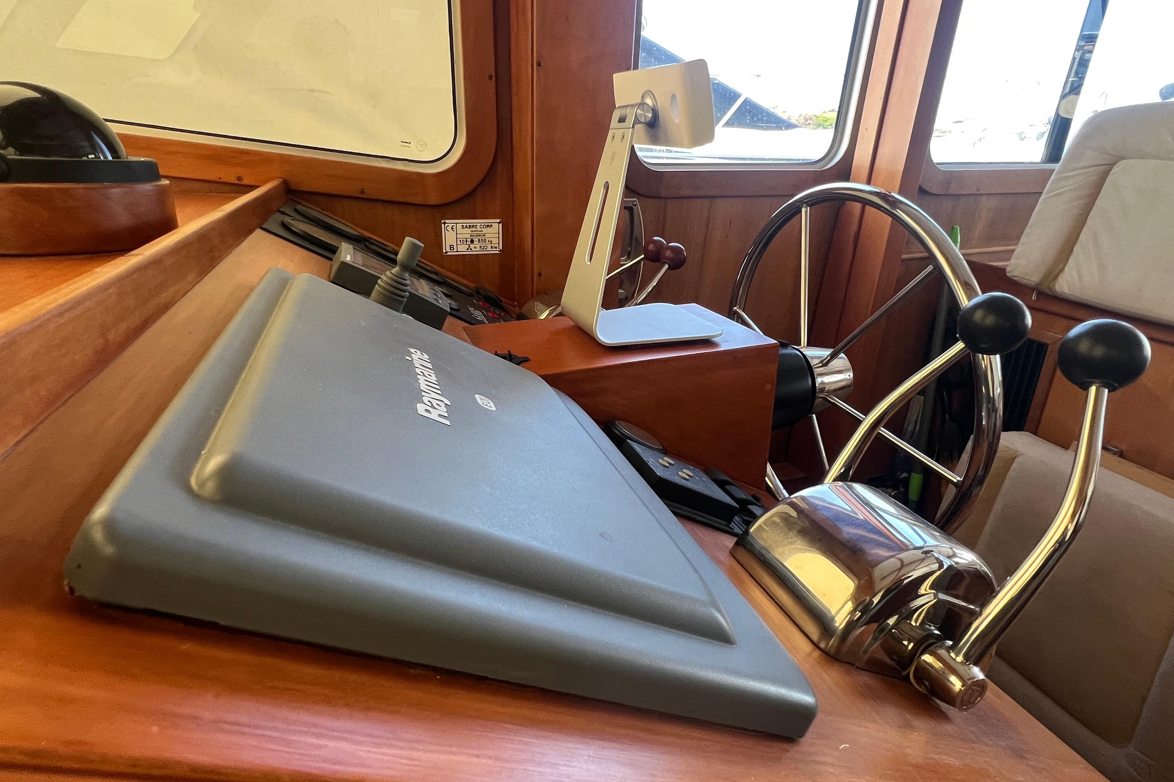 2005 Sabre Flybridge helm with Raymarine navigation and dual throttle controls.