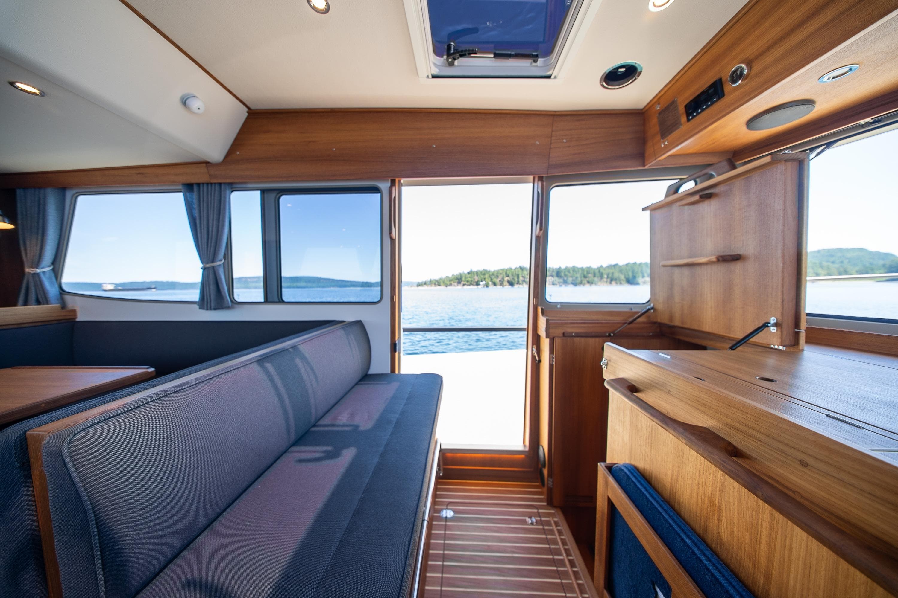 Interior of 2026 Targa 41 boat with wooden finish and scenic water view.