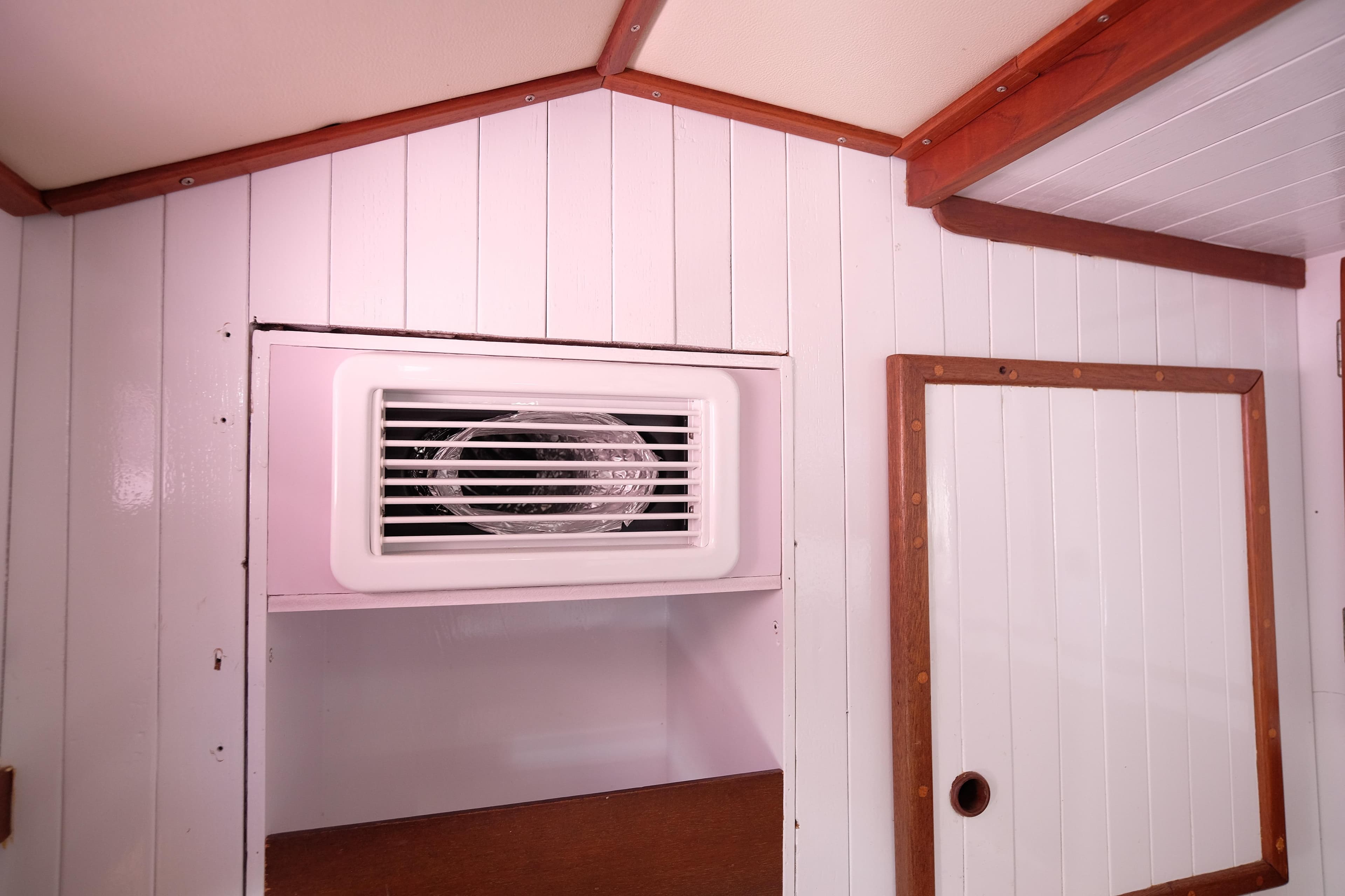 Interior of 1981 Corbin 39 boat with white paneling and wooden trim.