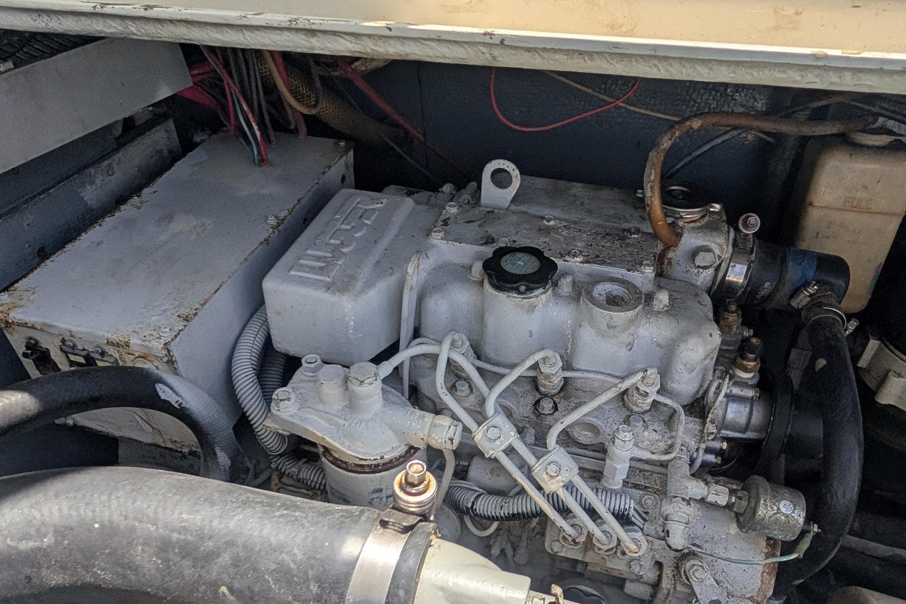 Engine compartment of a 1973 Bertram 31 Sportfisher boat, showcasing mechanical components.