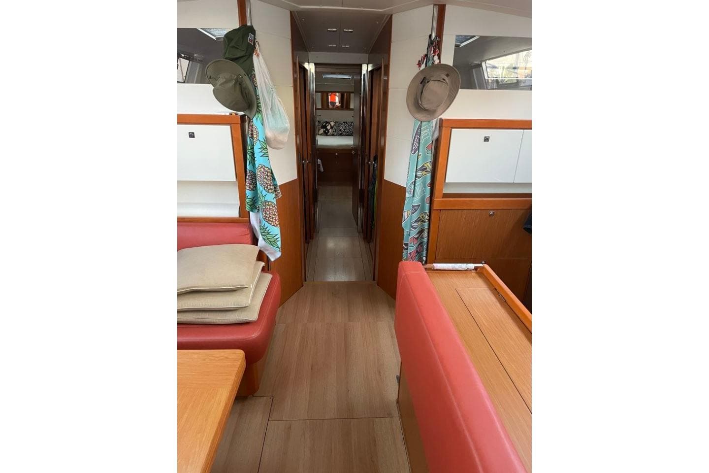 Interior of 2015 Beneteau Sense 55 yacht, featuring cozy seating and wooden flooring.