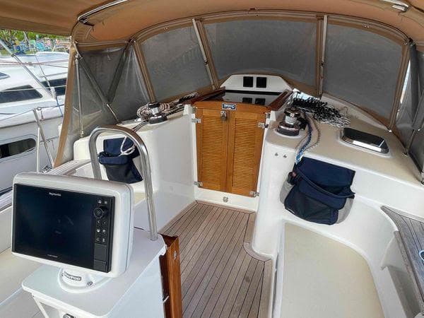 Cockpit of 2020 Tartan 395 sailboat with navigation equipment and wooden flooring.