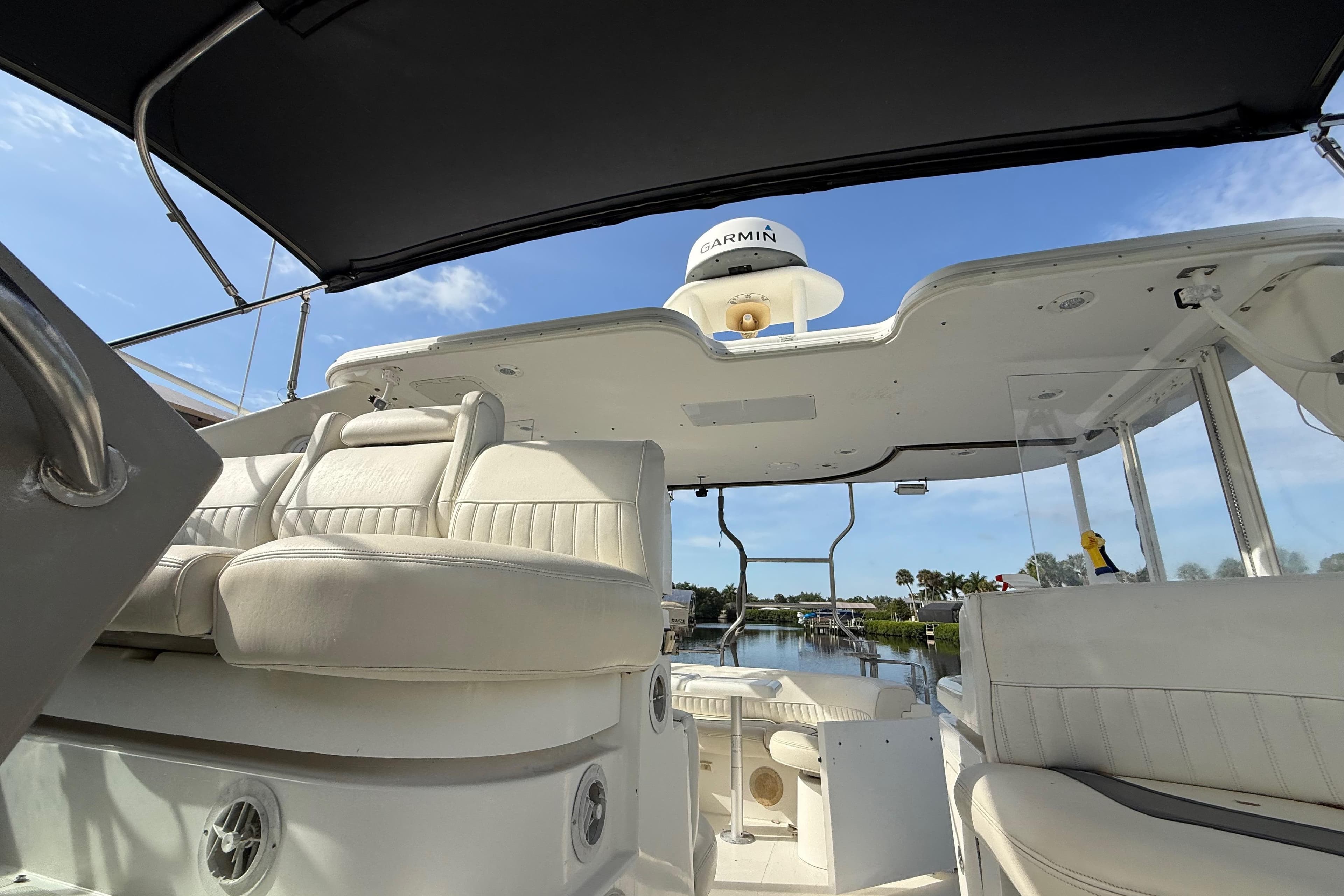 2002 Cruisers Yachts 4450 Express Motoryacht interior with white seating and Garmin equipment.