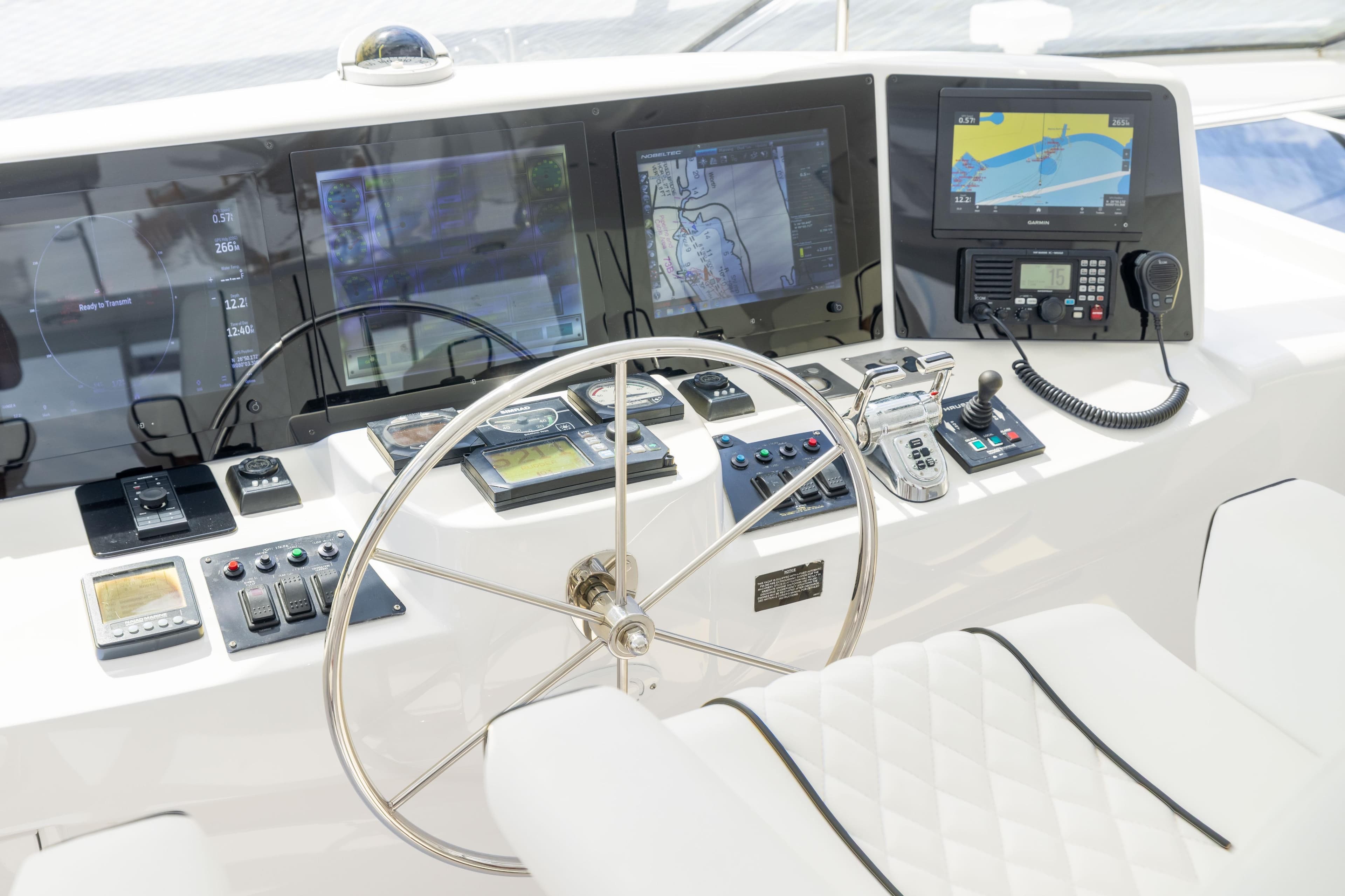 Helm of 2005 Hatteras 80 Motor Yacht with advanced navigation controls and displays.
