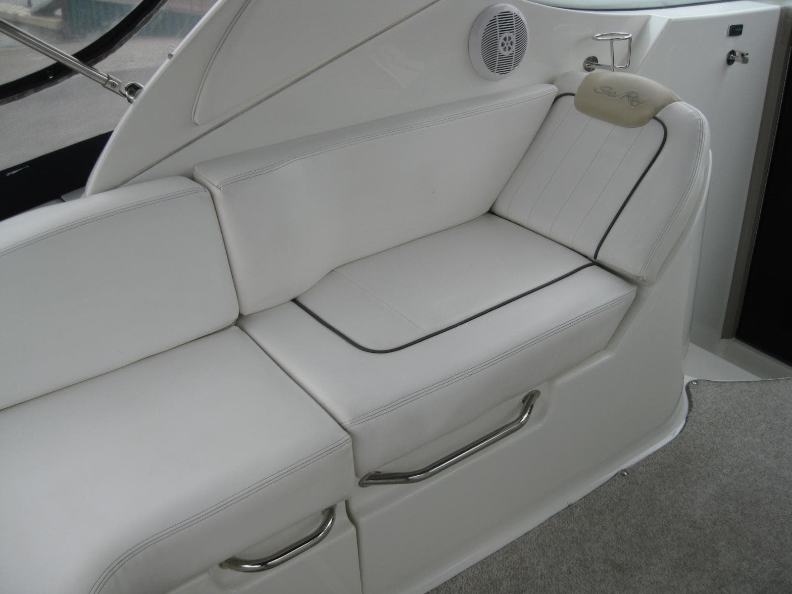 Interior of 2009 Sea Ray 270 Sundancer with white seating area.