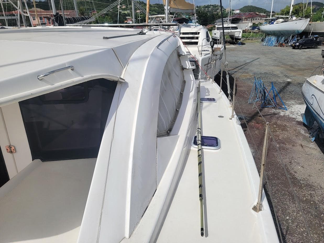 2015 Leopard 44 catamaran docked, showcasing sleek design and spacious deck.