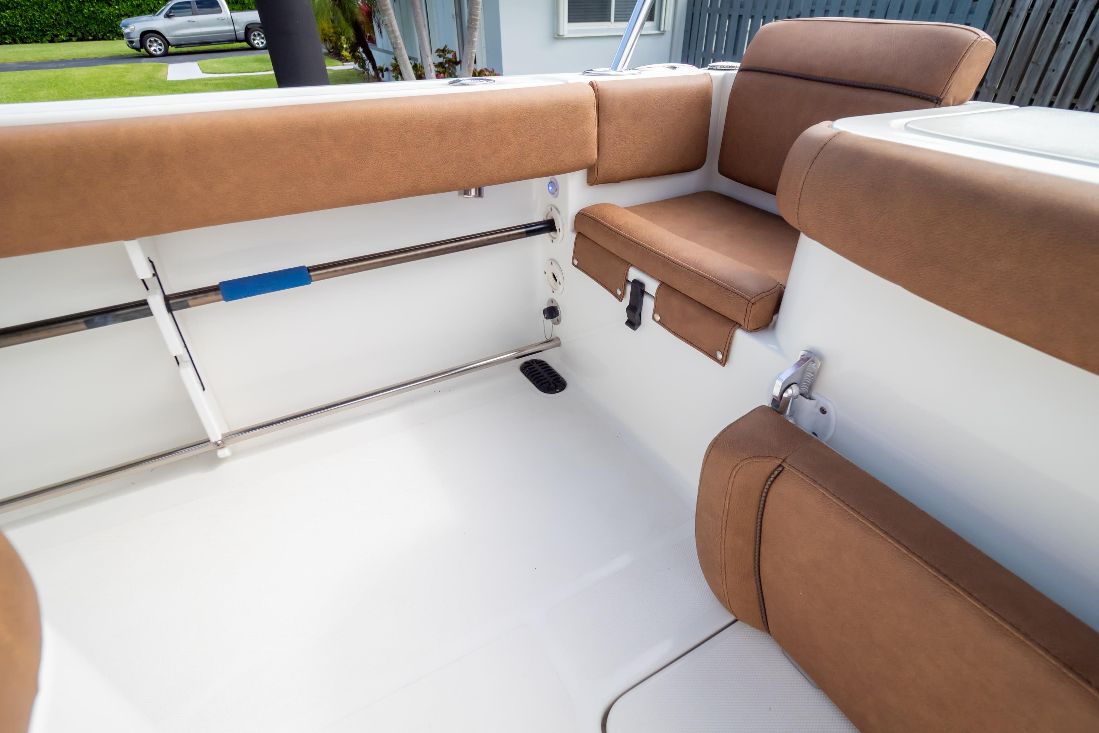 2021 Sea Hunt Gamefish 27 boat interior with brown cushioned seating.