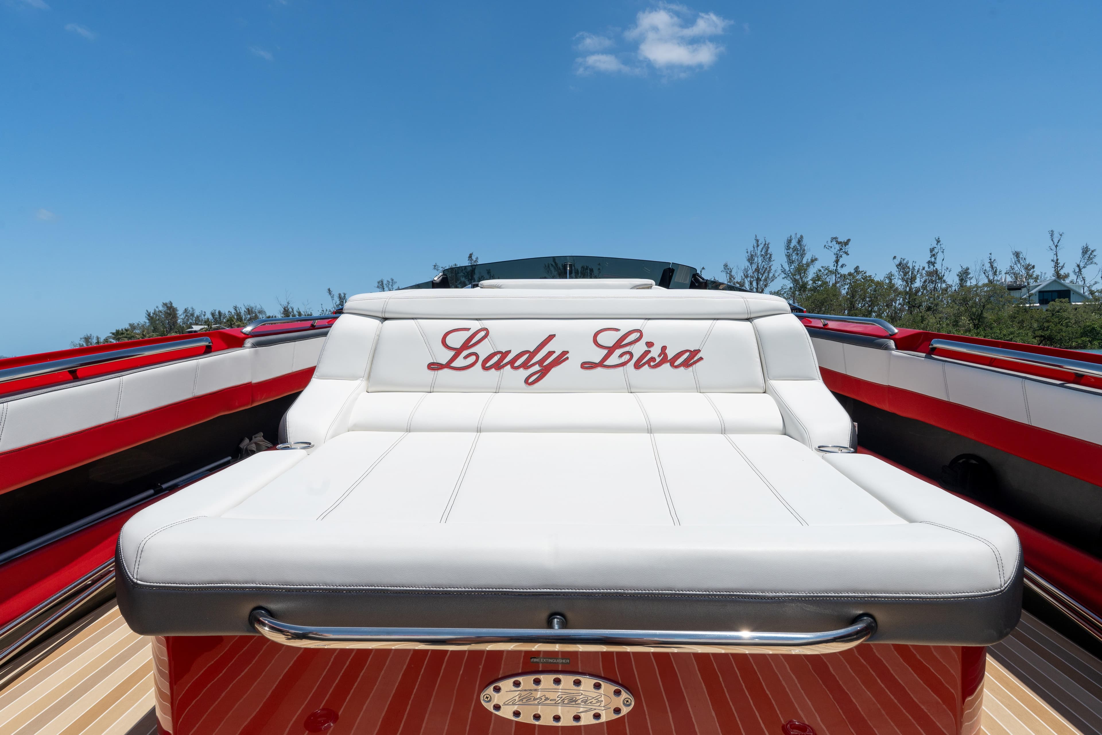 2023 Nor-Tech 55 Flyer boat with "Lady Lisa" on white seating, under clear blue sky.