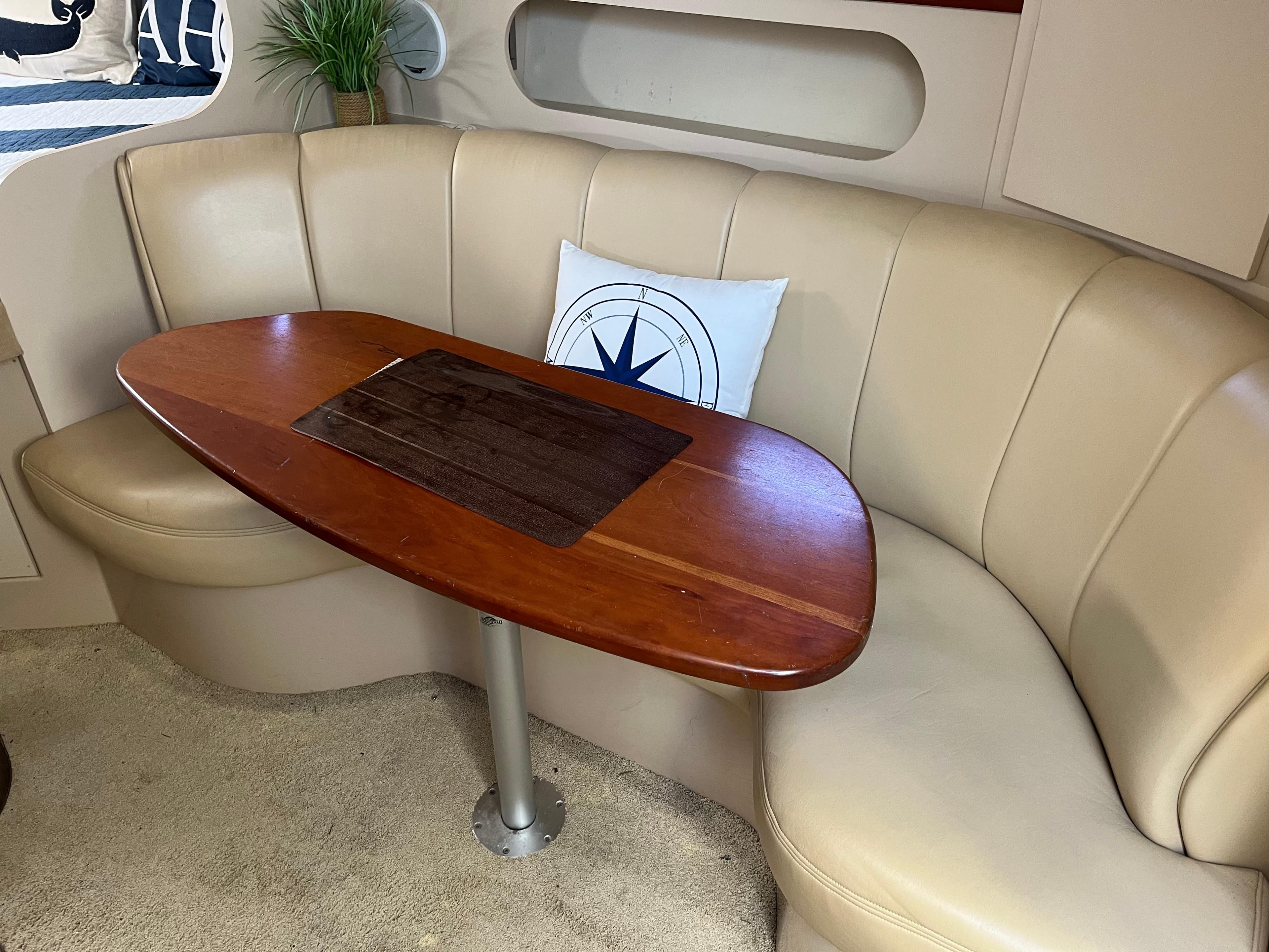 2001 Cruisers Yachts 2870 Express interior with beige seating and wooden table.