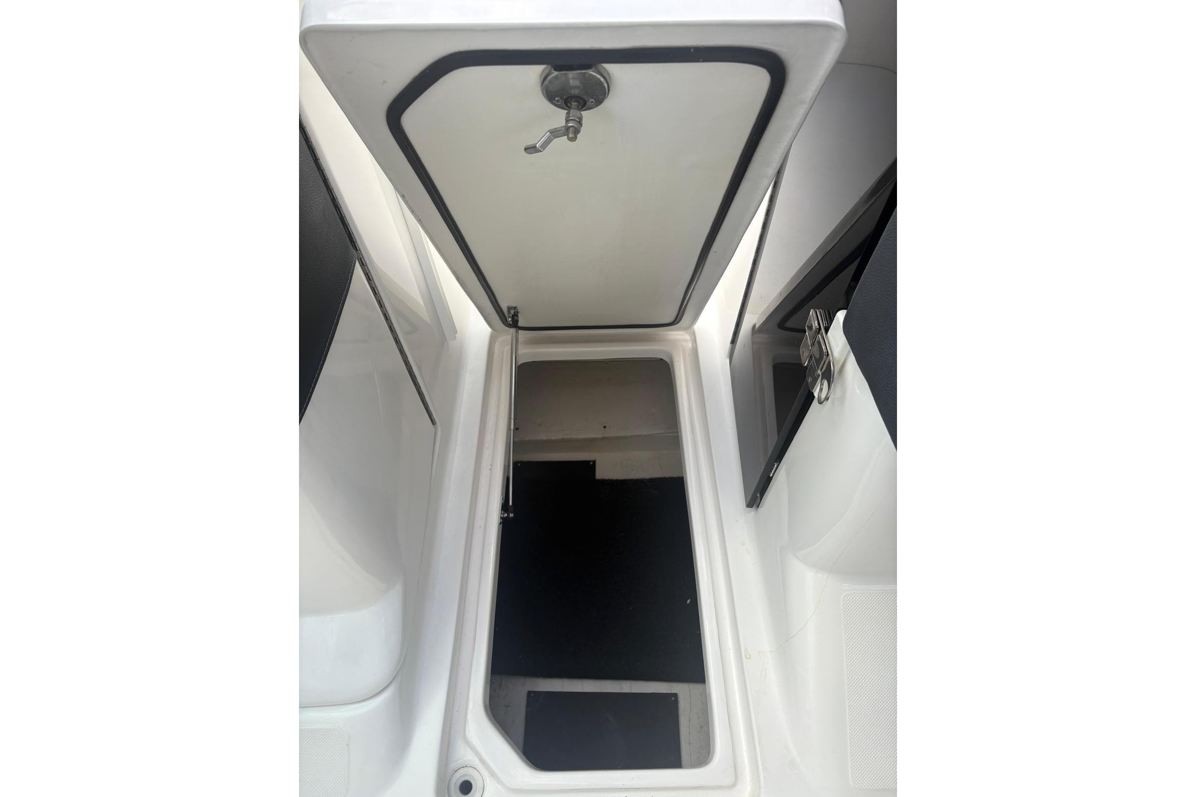 2022 Regal 29 OBX boat interior storage compartment with open hatch.