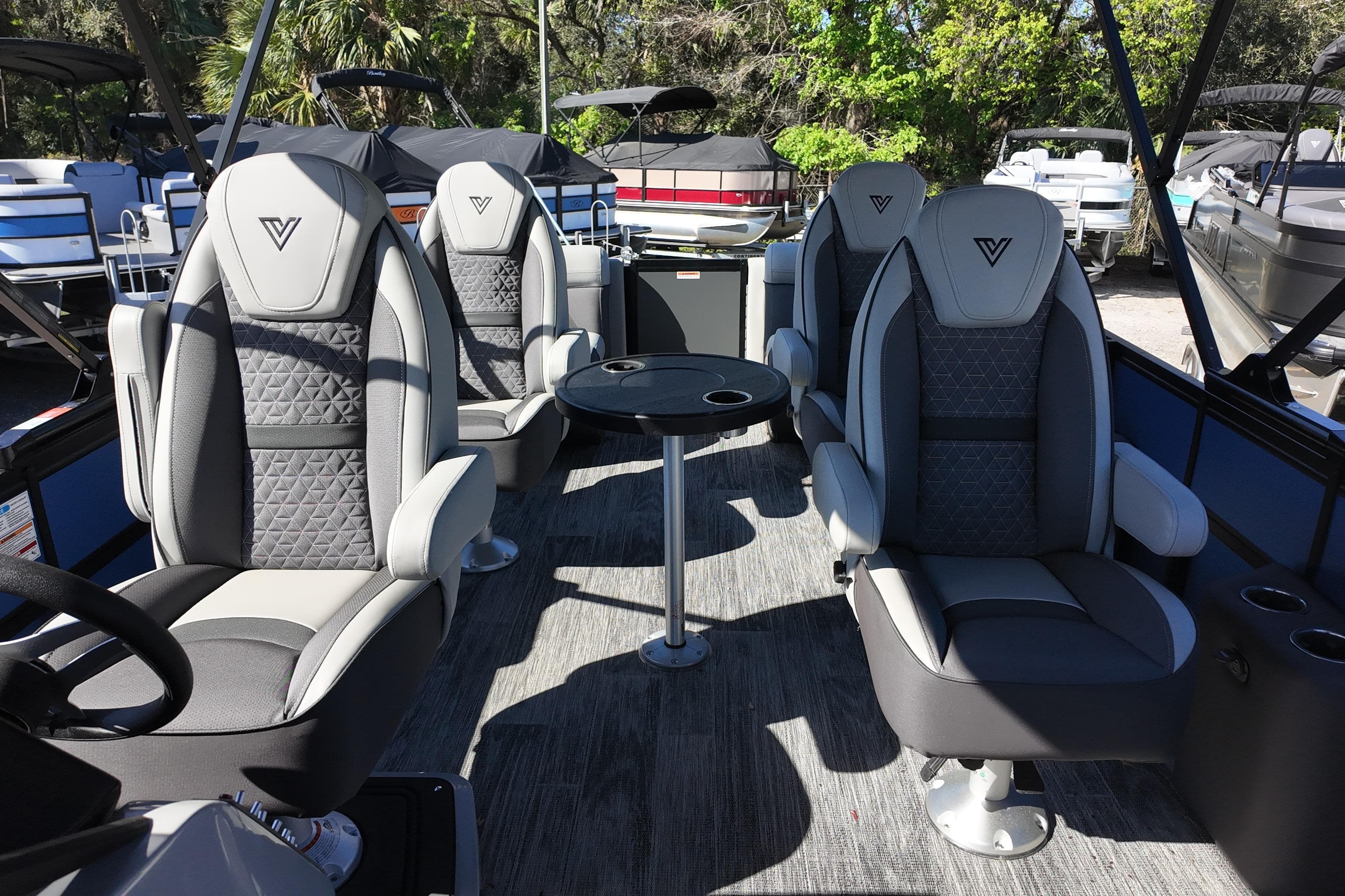 Interior of 2025 Viaggio Z24Q boat with luxurious seating and table.