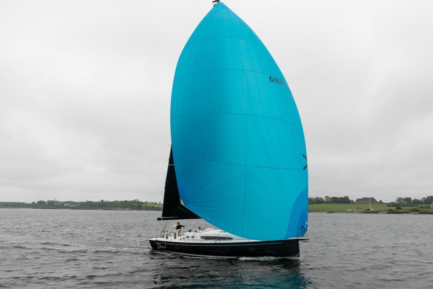 2026 J Boats J/40 sailboat with blue spinnaker on calm water.
