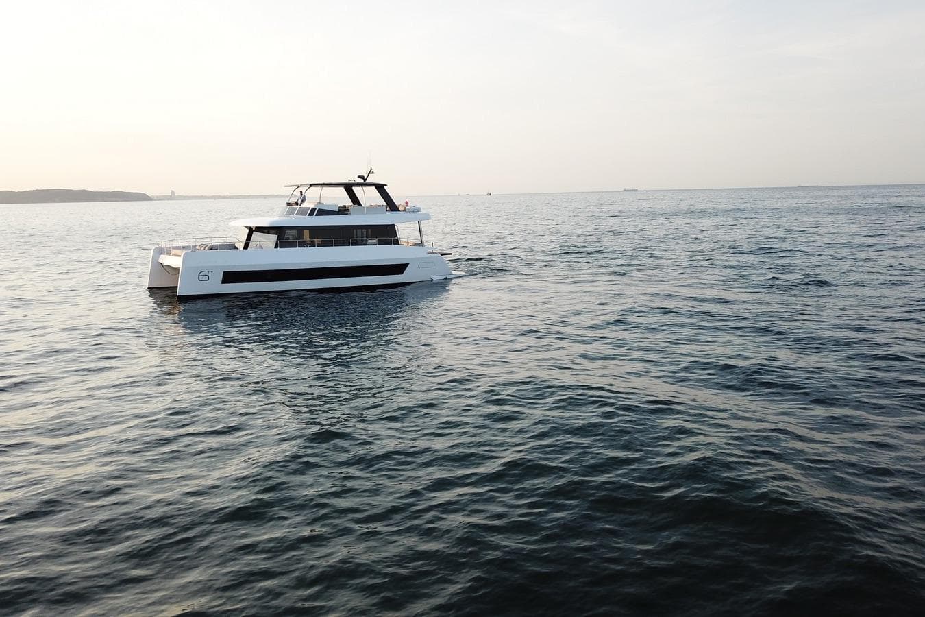 Luxury Moon Yachts 6ty 2026 model cruising on serene ocean waters.