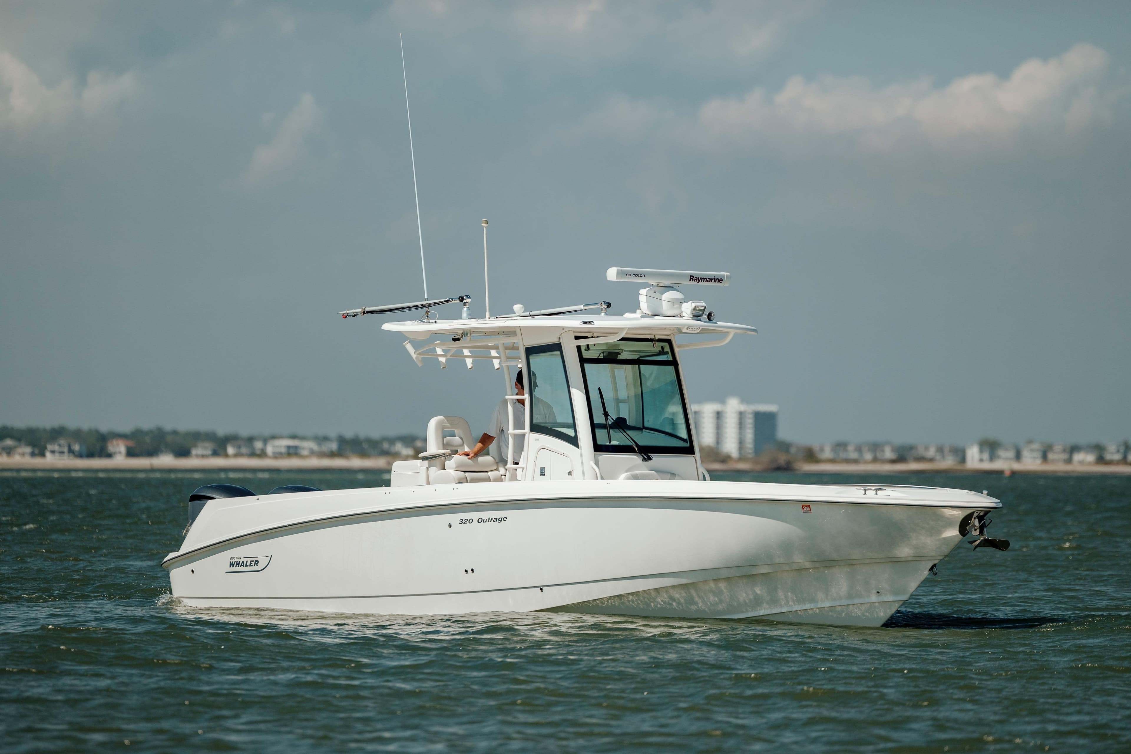 2013 Boston Whaler 320 Outrage boat cruising on open water.