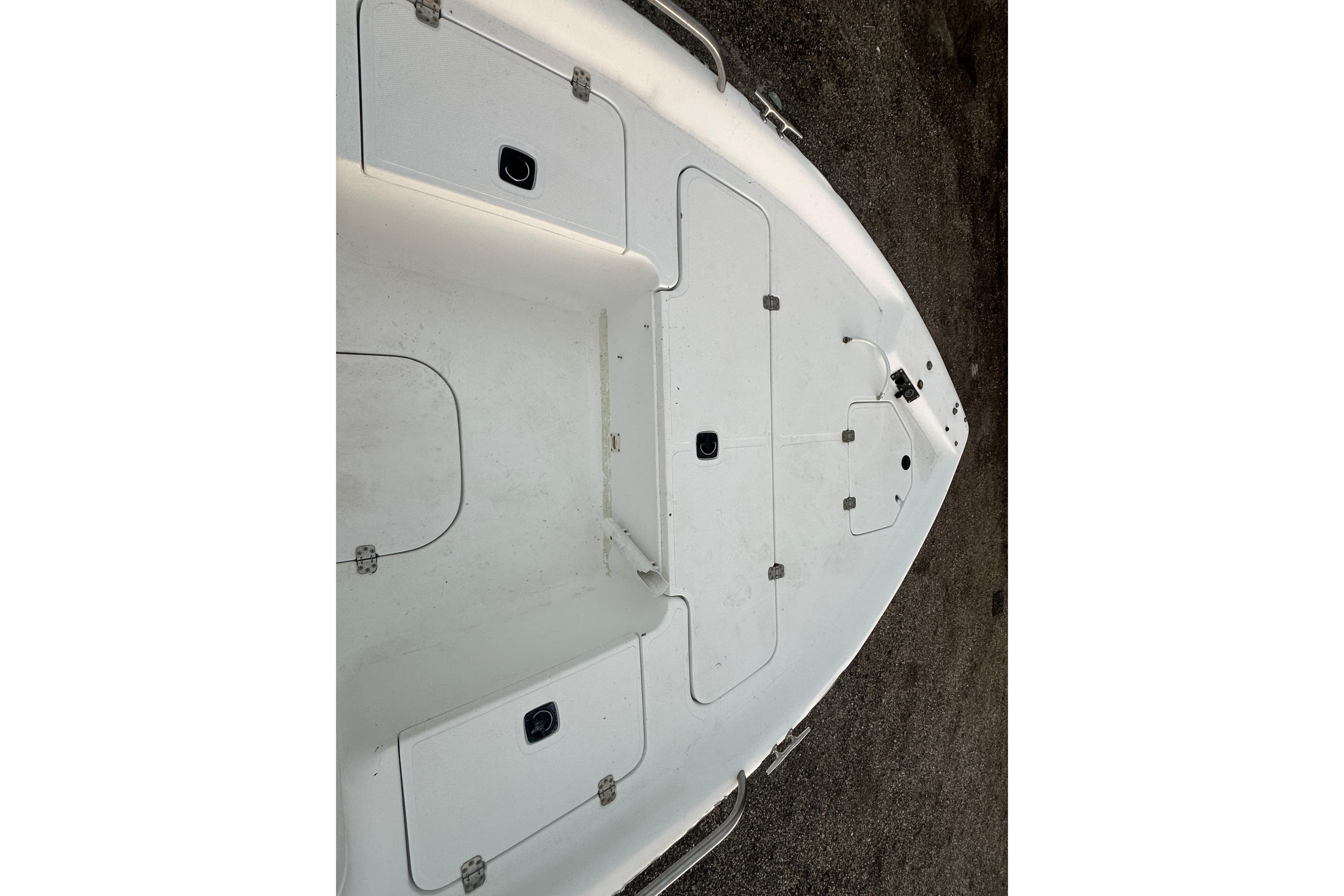 2002 Polar 2300 Bay boat deck with storage compartments and clean white surface.