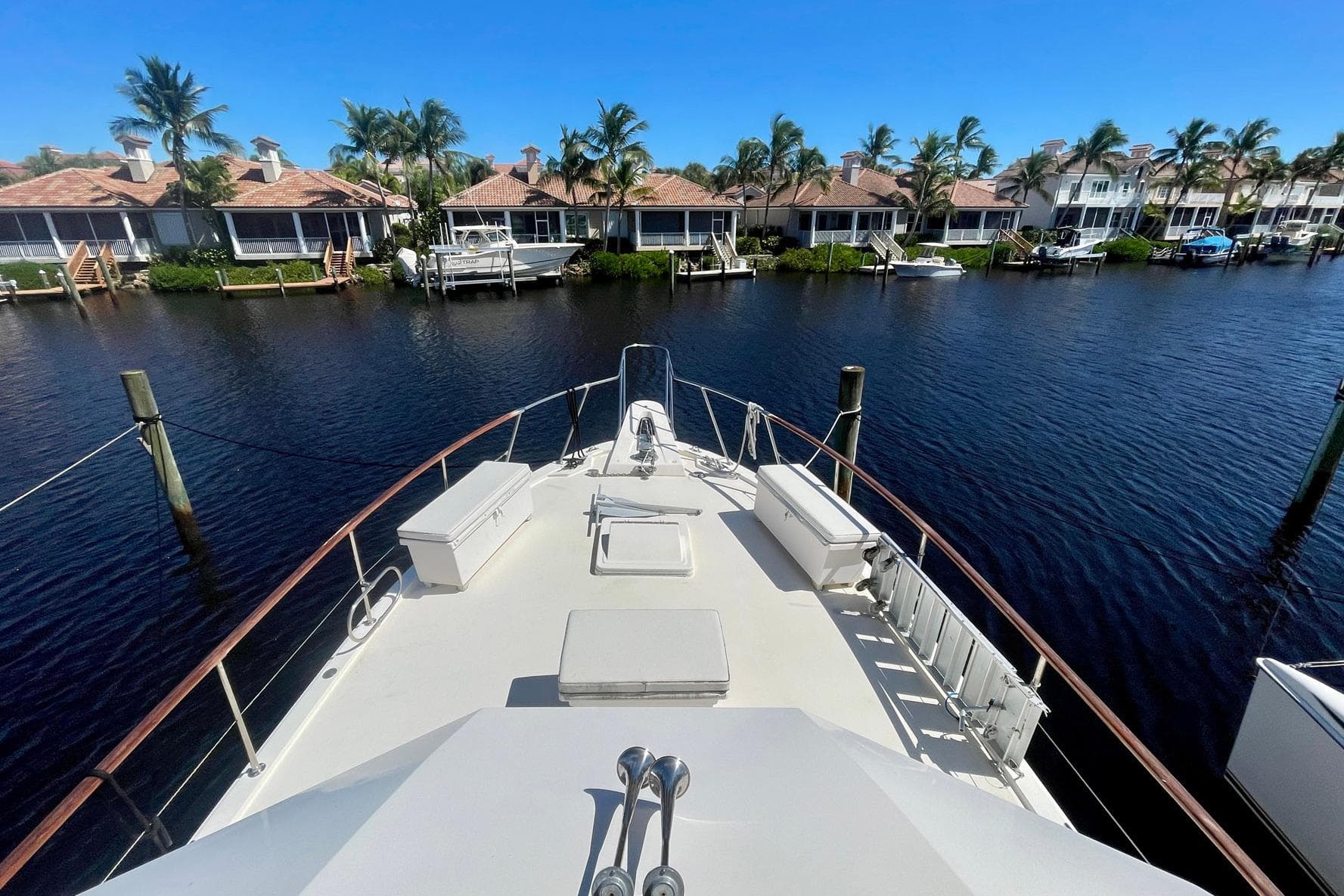 1981 Hatteras 48 Motor Yacht docked in scenic waterfront neighborhood.