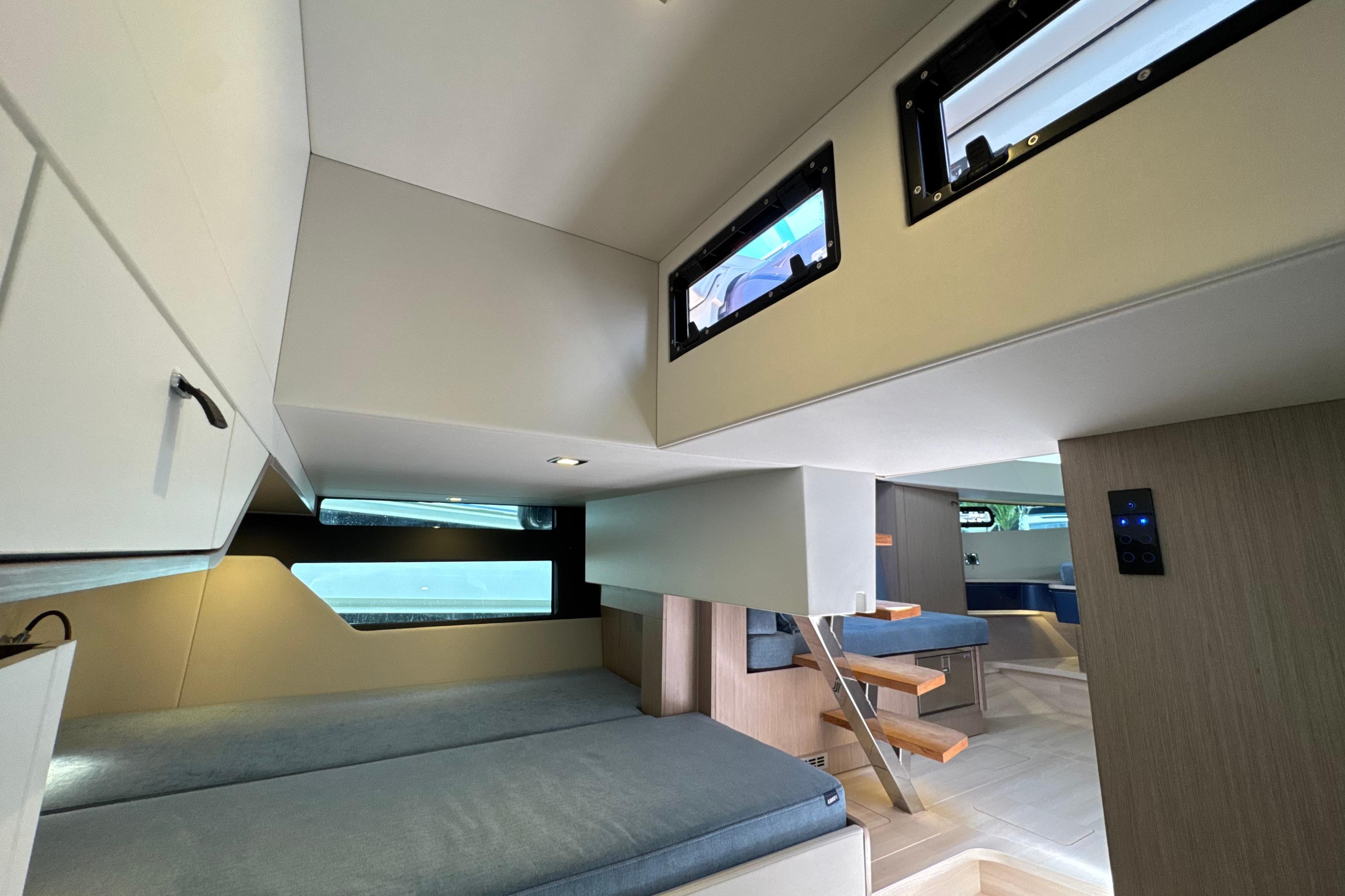 2023 Fjord 41 XL yacht interior with modern design, featuring cozy sleeping area and wooden accents.
