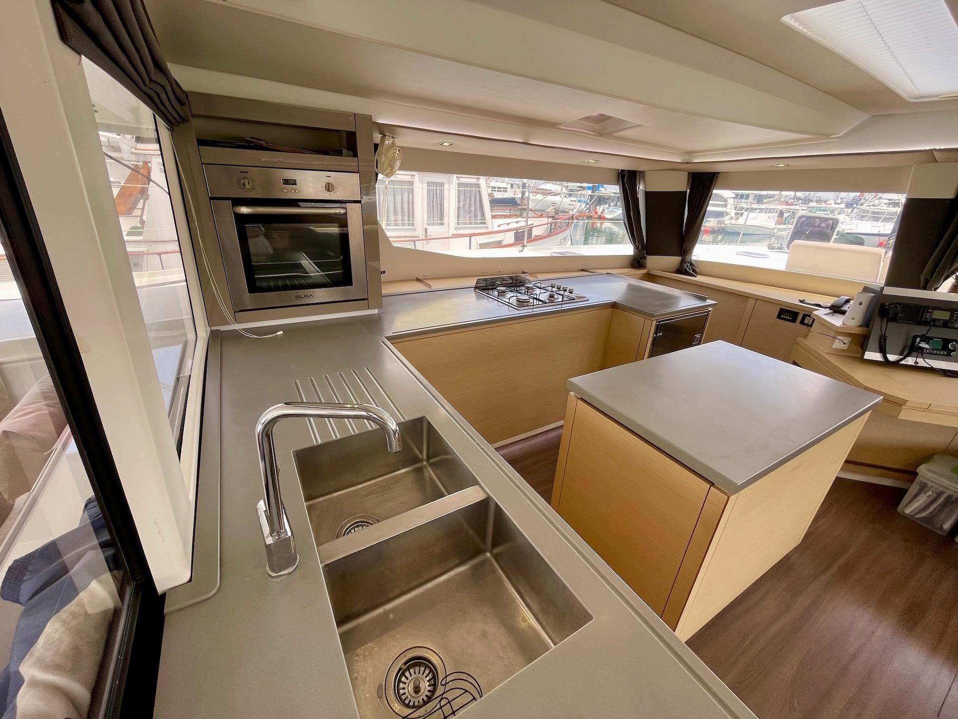 Modern kitchen interior of 2017 Fountaine Pajot SABA 50 catamaran with stainless steel appliances.