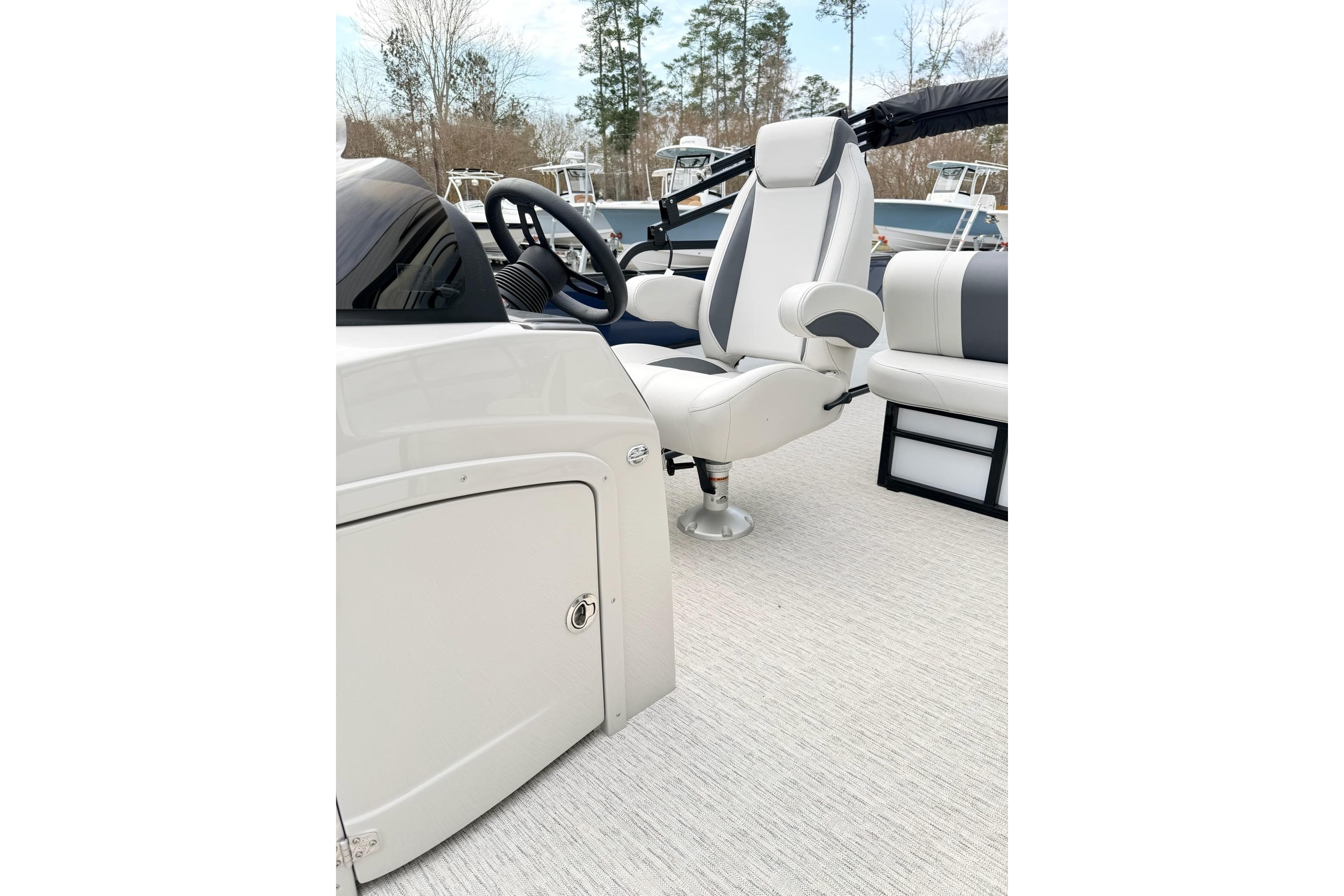Captain's chair and helm on 2026 Coach Pontoons 243 FLC boat.