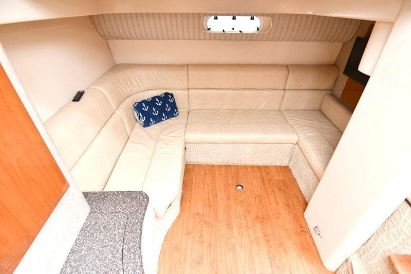 2008 Formula 40 Performance Cruiser interior with beige seating and nautical-themed pillow.