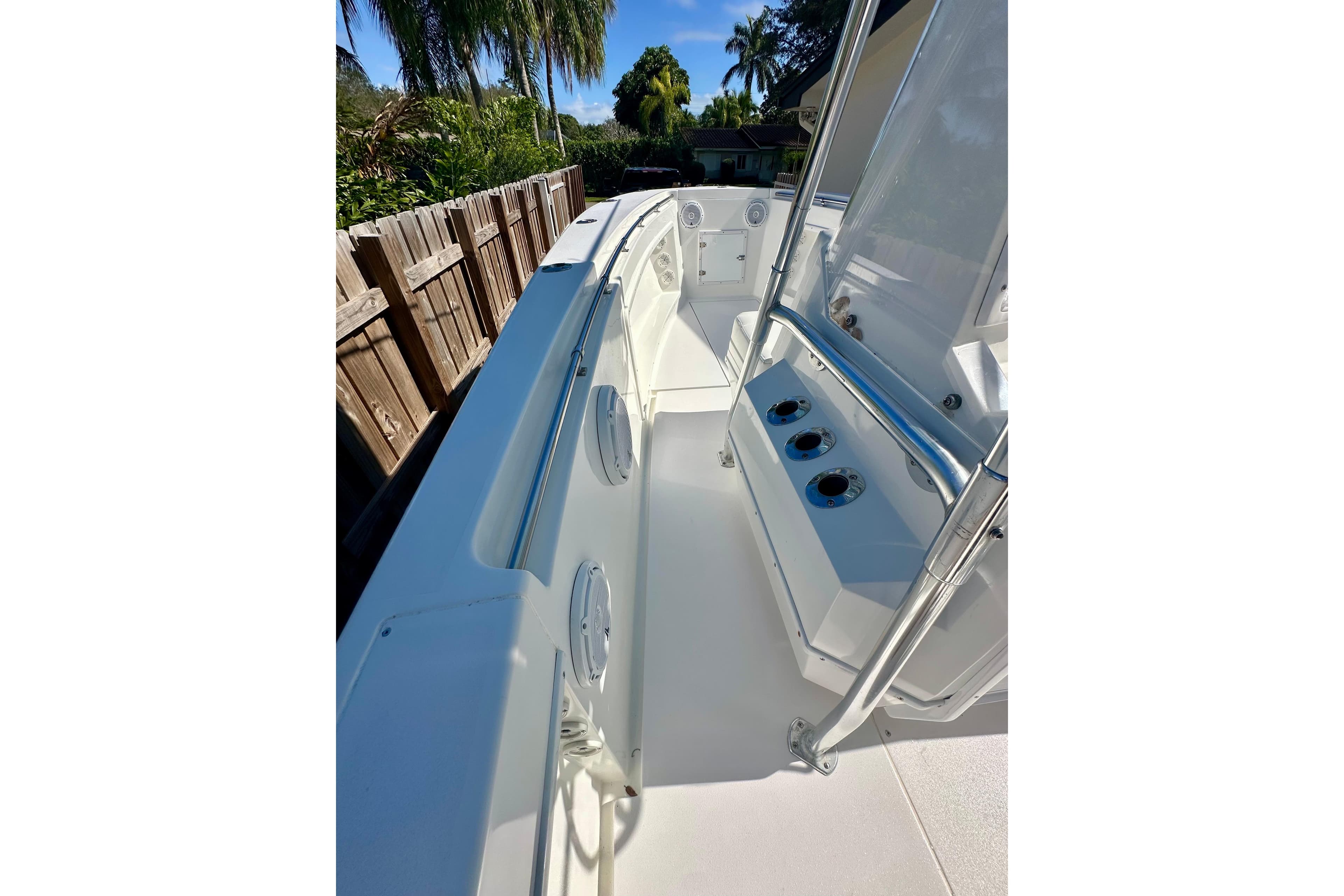 2001 Contender 23 Open boat interior with console and seating, surrounded by lush greenery.