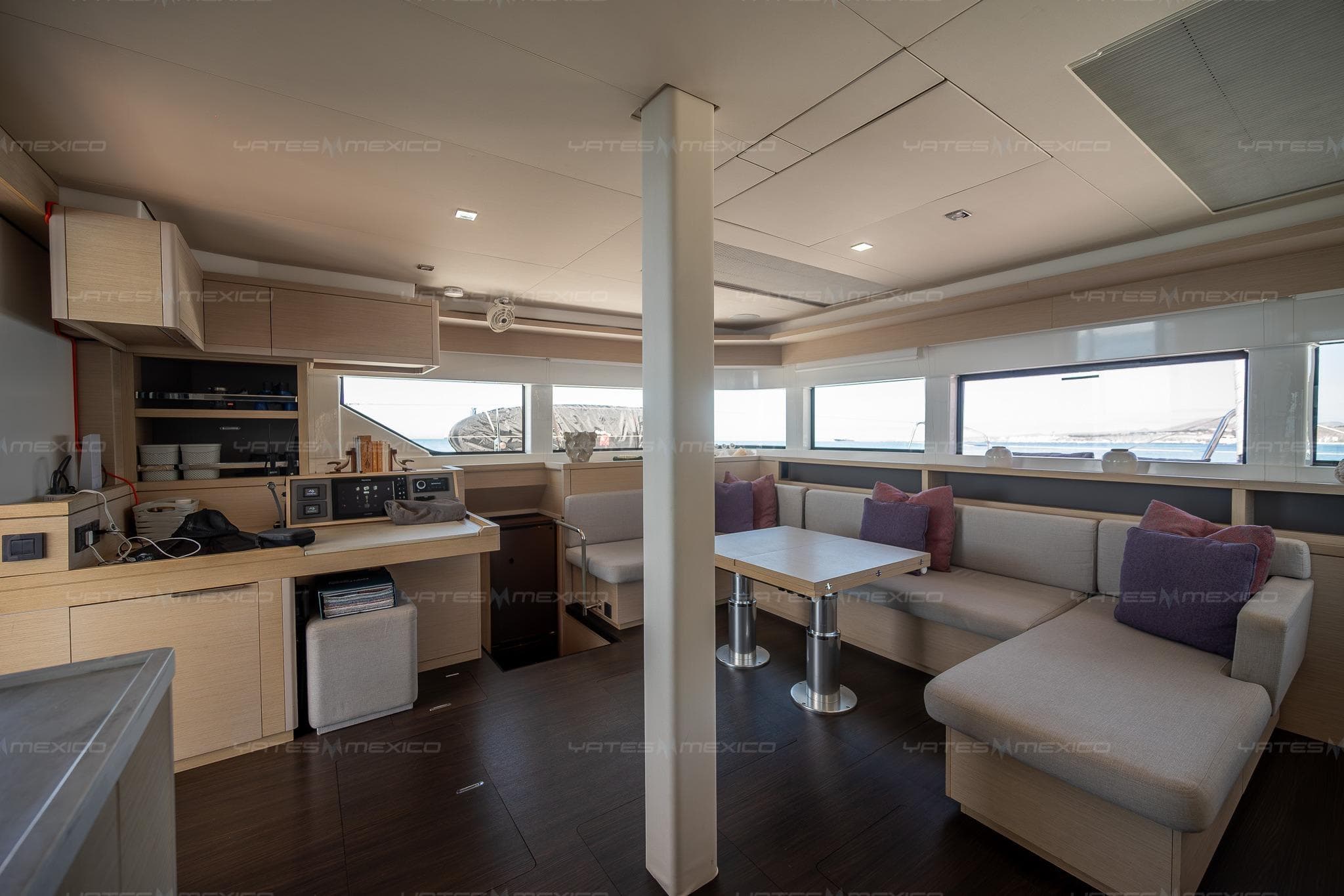 Luxurious interior of 2023 Lagoon 55 yacht with modern kitchen and seating area.