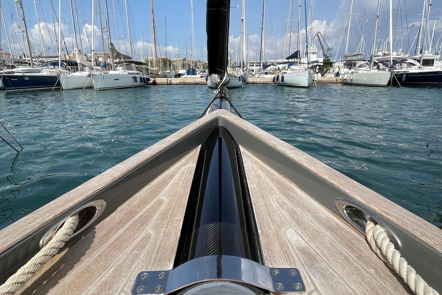 Bow view of 2009 Wally Wallynano 37 yacht in a marina, surrounded by sailboats.