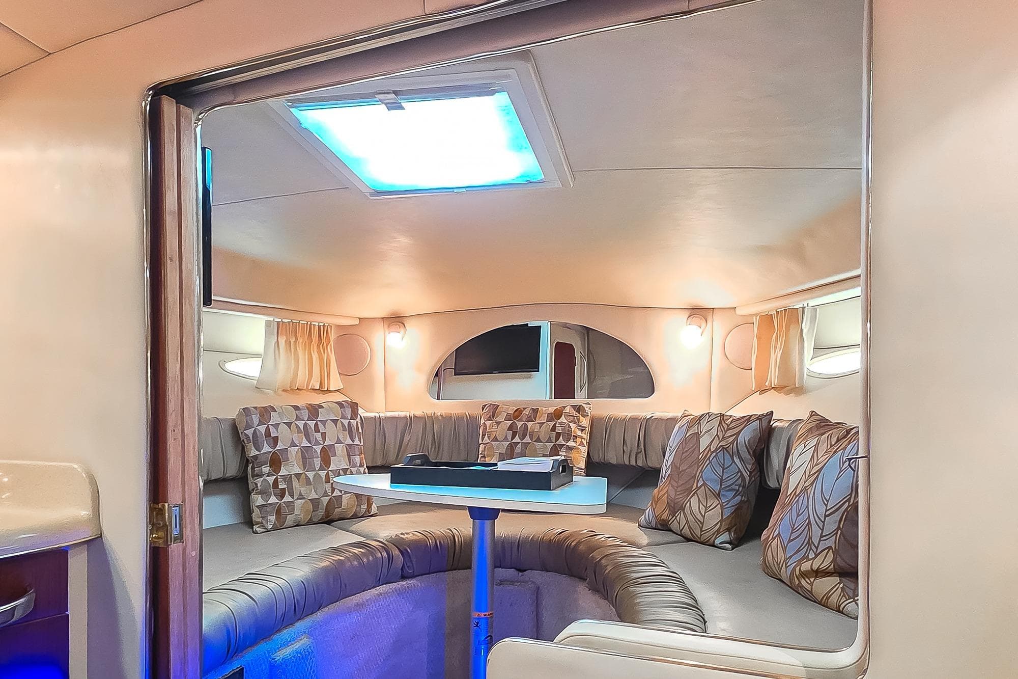 Interior of 1998 Sea Ray 330 Express boat with cozy seating and modern decor.