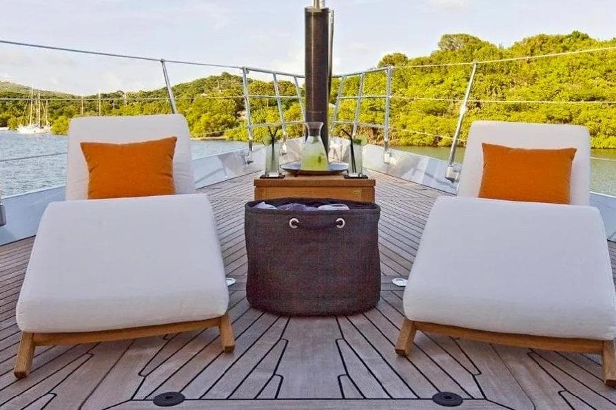 Luxurious deck of 2009 Bloemsma Van Breemen 40m yacht with lounge chairs and scenic view.
