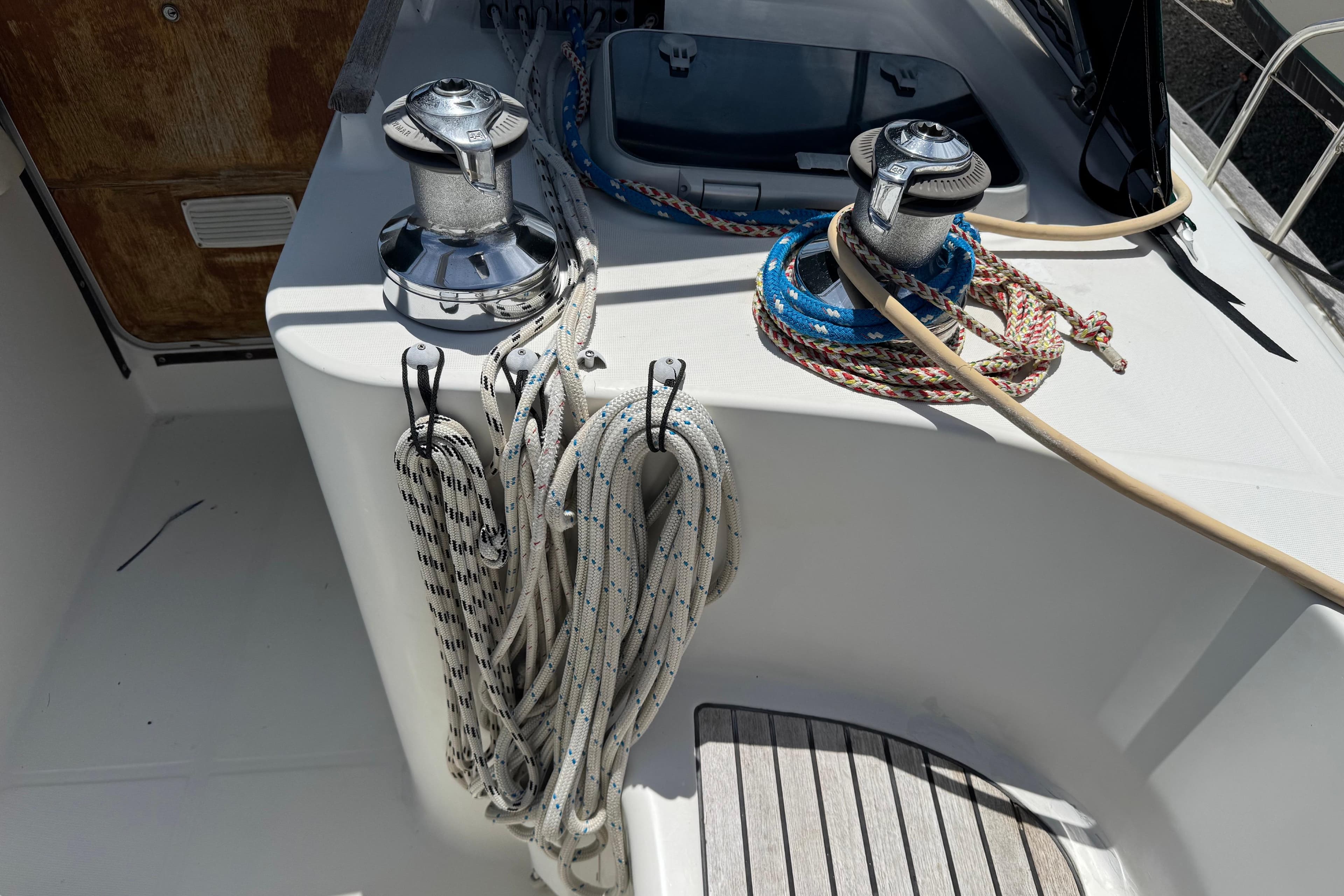 Deck of 1997 Beneteau Oceanis 461 sailboat with winches and ropes.