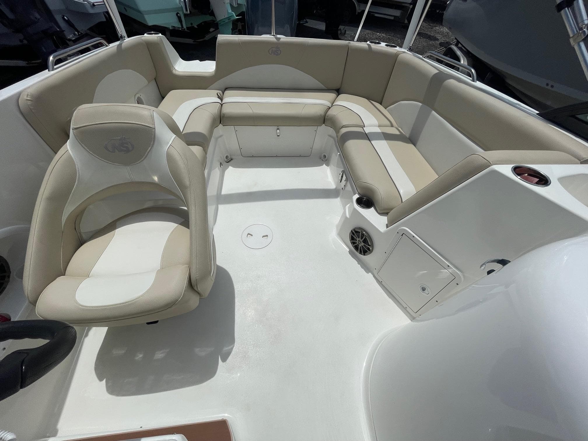 2018 NauticStar 223DC Sport Deck interior with beige seating and white deck.