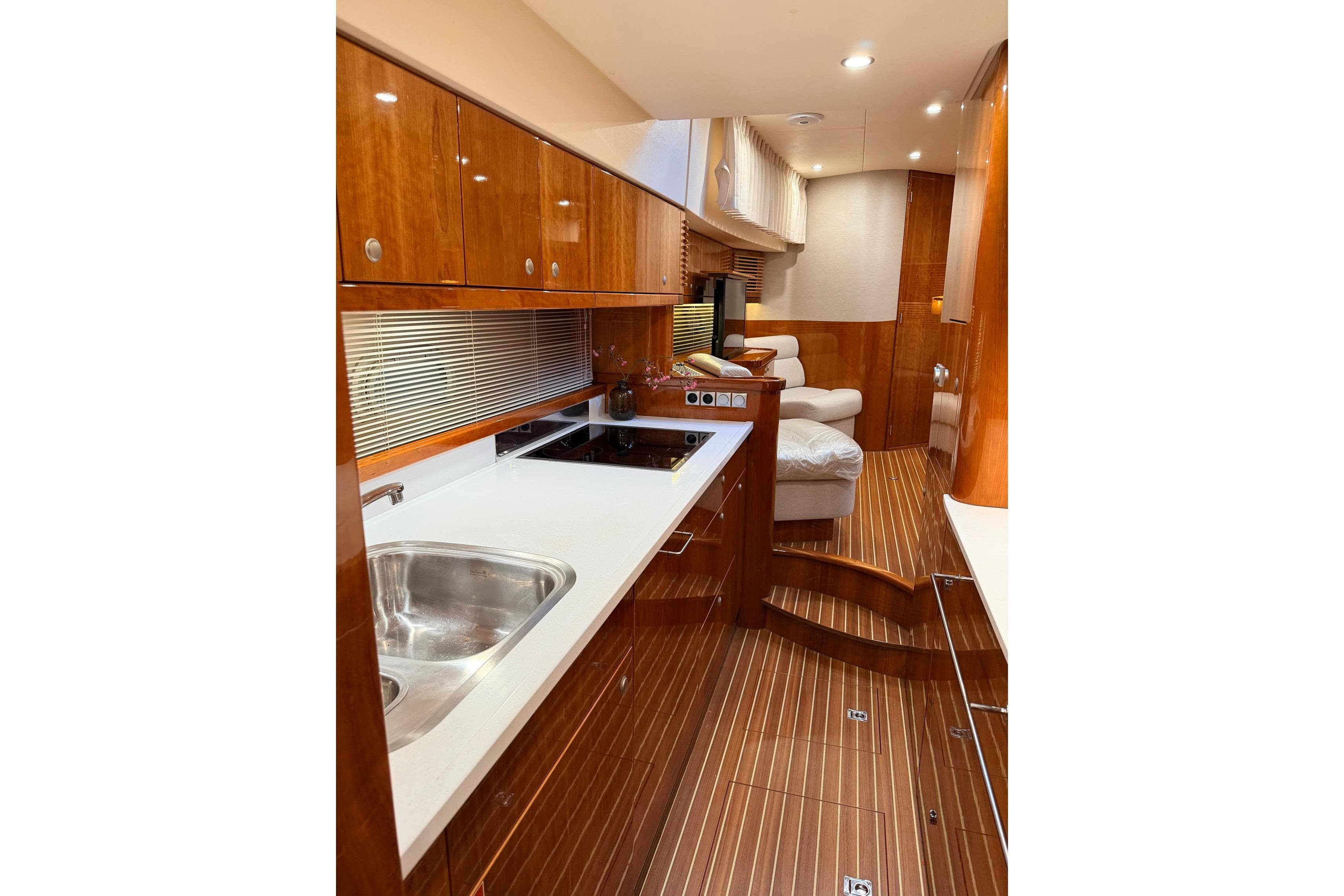 Luxurious interior of 2017 Elling E4 yacht with modern kitchen and seating area.