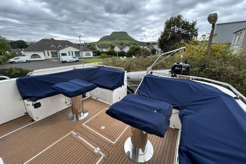 2018 Redbay Boats 1650 Explorer Cabin RIB with blue seating, docked near residential area.