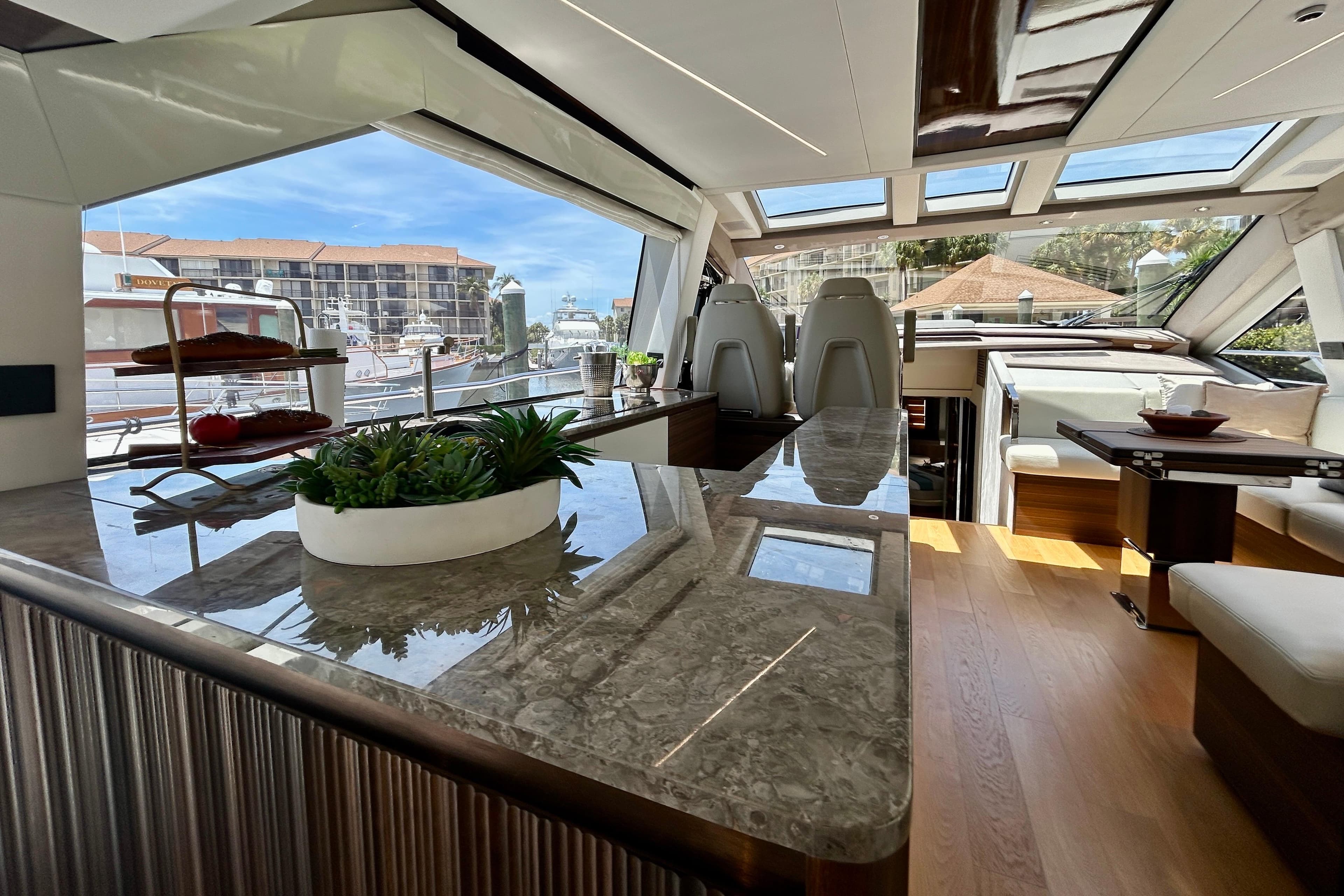Luxurious interior of 2024 Aicon Vivere 66 yacht with modern design and panoramic windows.
