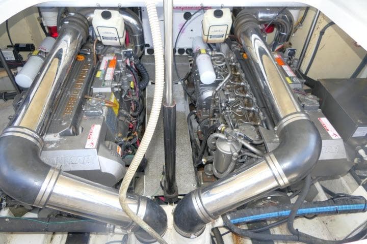 Engine room of a 2003 Thunderbird Formula 40PC boat, showcasing dual engines and exhaust systems.