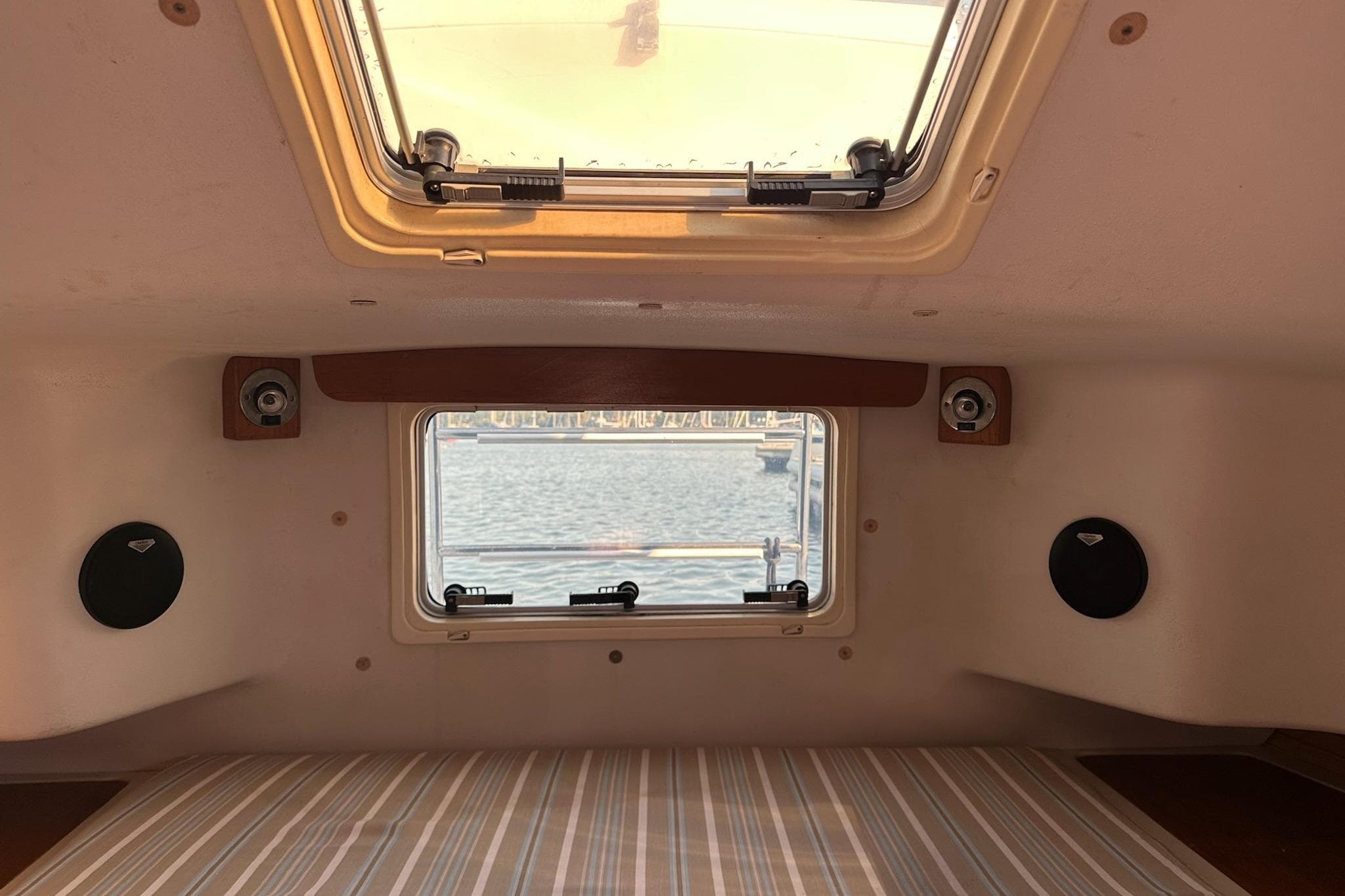 Interior cabin view of a 1997 Catalina Morgan 38 sailboat with window and speakers.