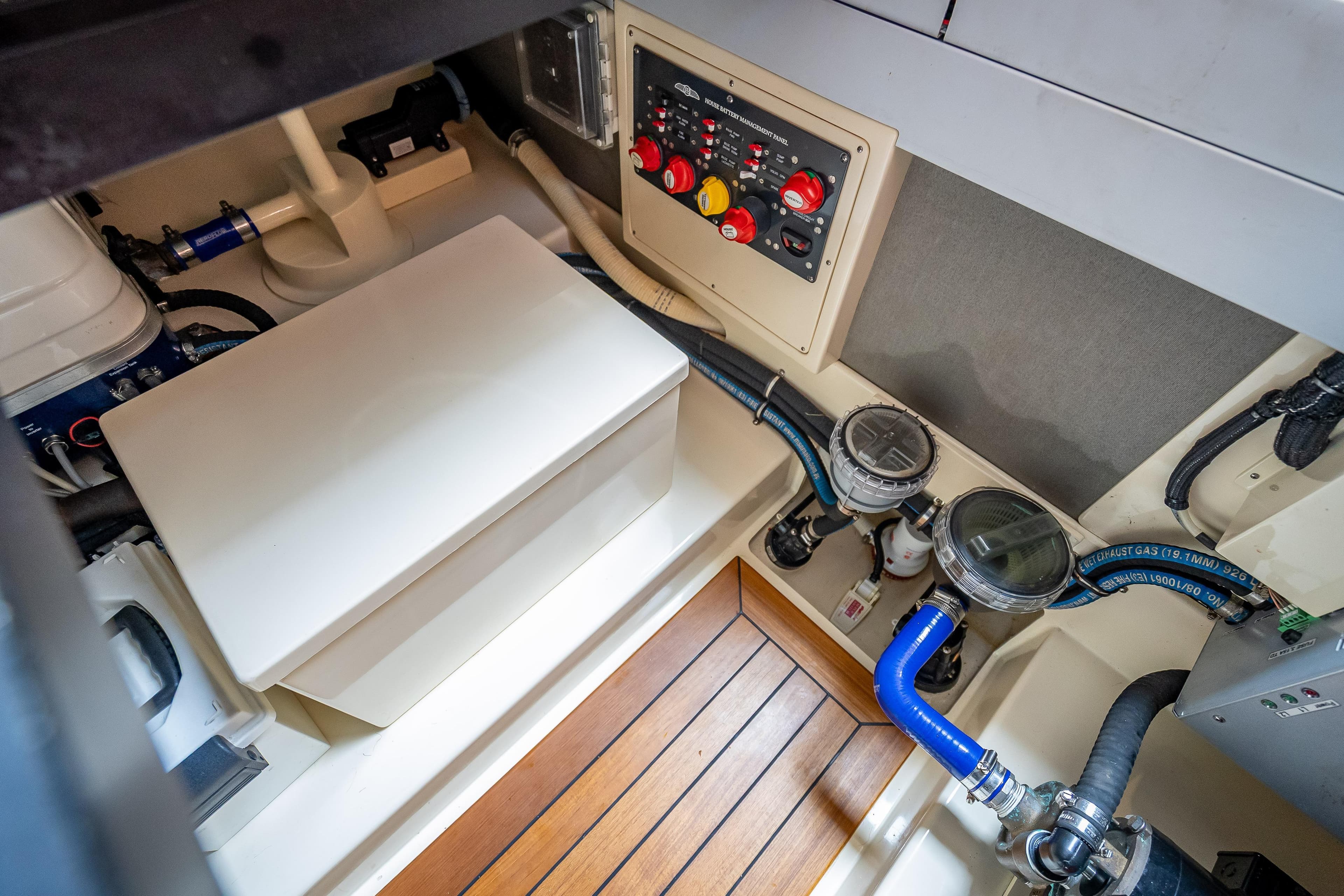 Engine room of 2018 Palm Beach Motor Yachts PB50, featuring control panel and piping.