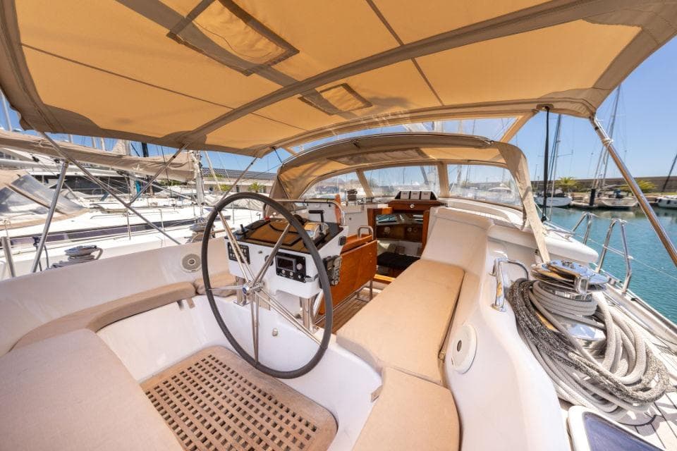 Luxury yacht cockpit of 2008 Discovery 55, featuring helm and seating area.