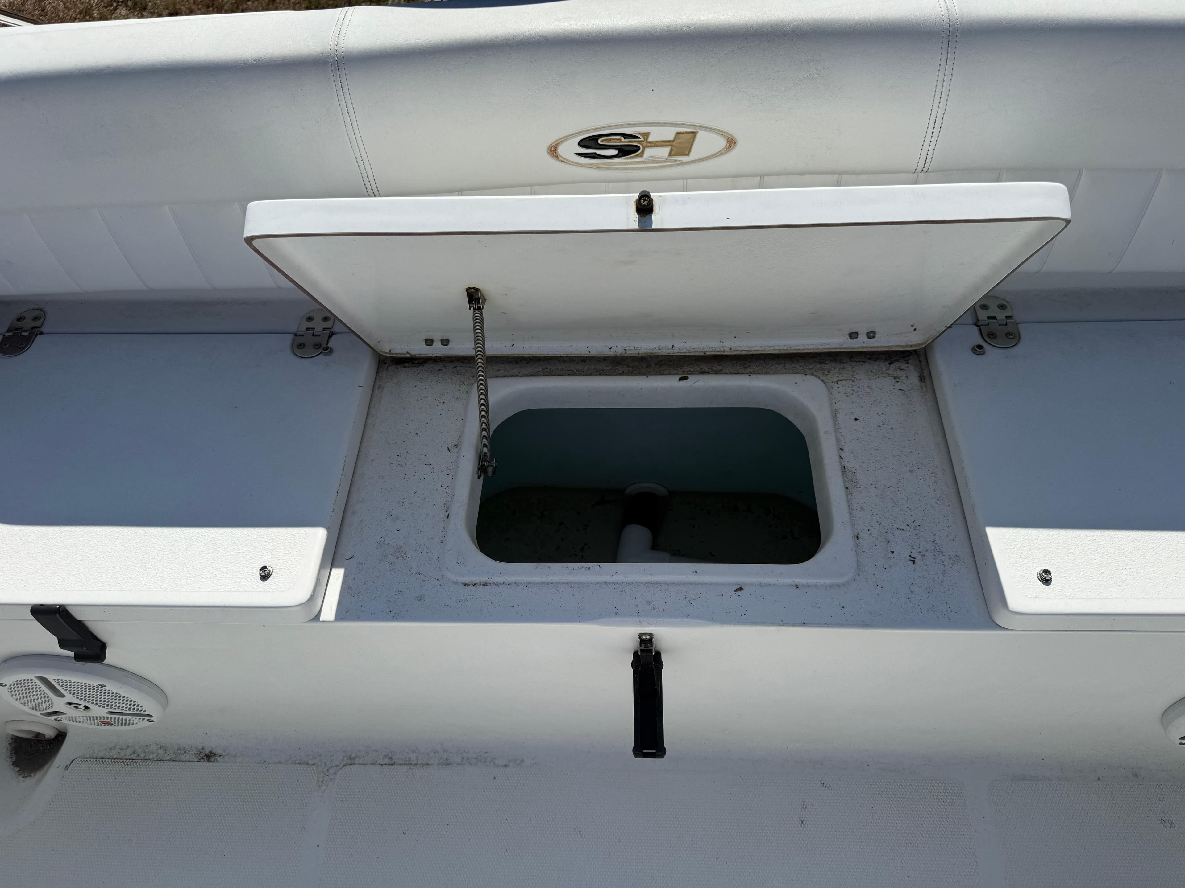 2012 Sea Hunt Escape 188LE boat storage compartment with open lid.