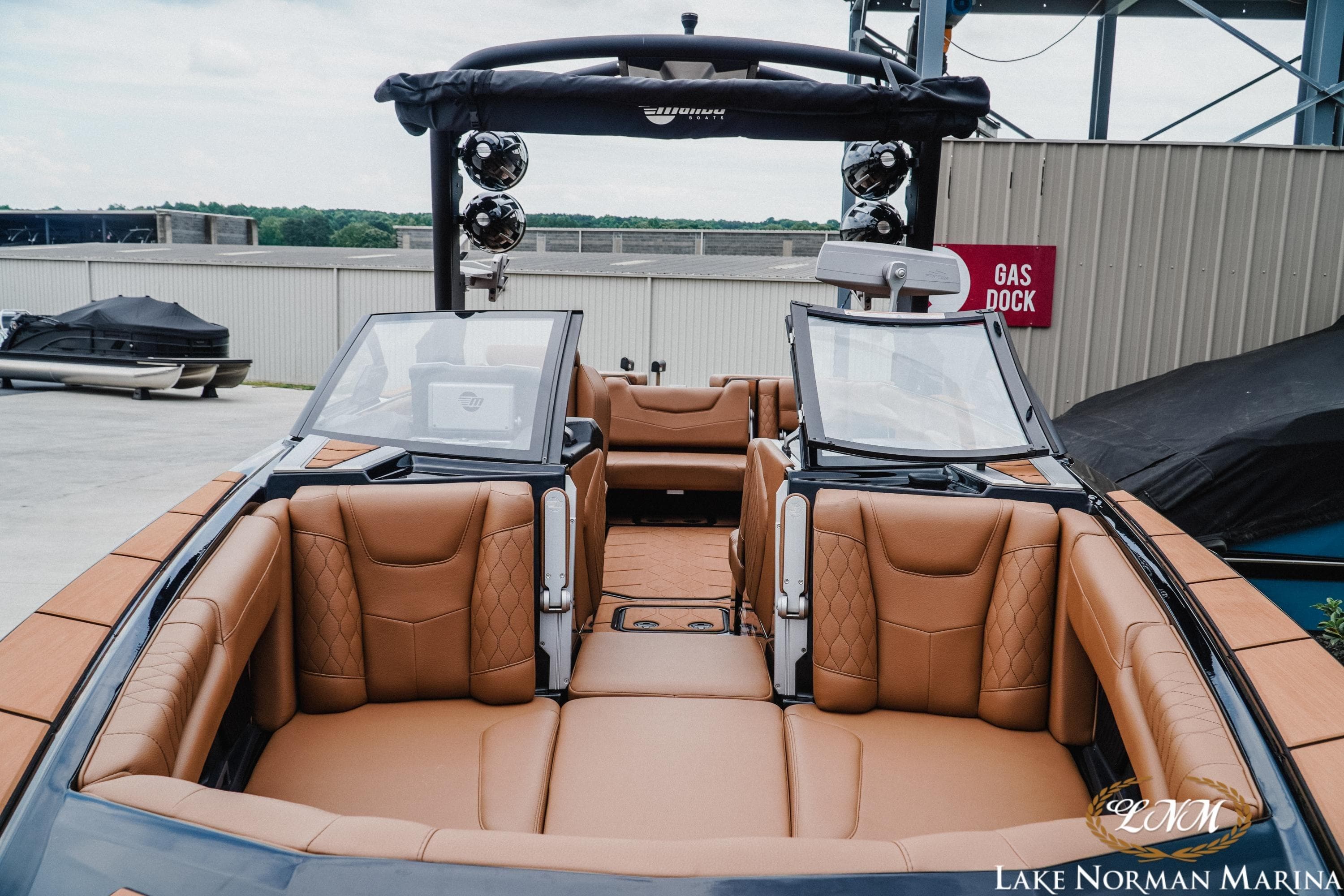 2021 Malibu M240 boat with luxurious tan leather seating at Lake Norman Marina.