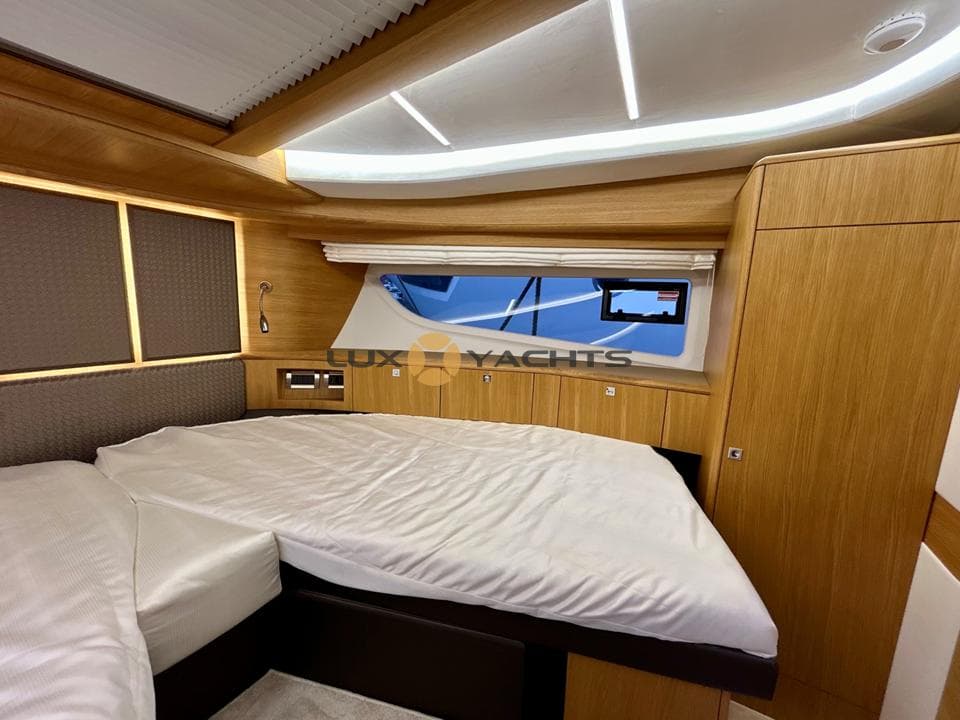 Luxurious cabin interior of 2021 Galeon 400 Fly yacht with modern wood finishes.