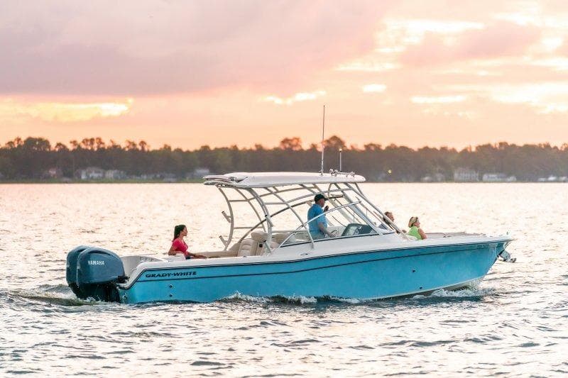 2027 Grady-White Freedom 285 boat cruising at sunset on calm waters.