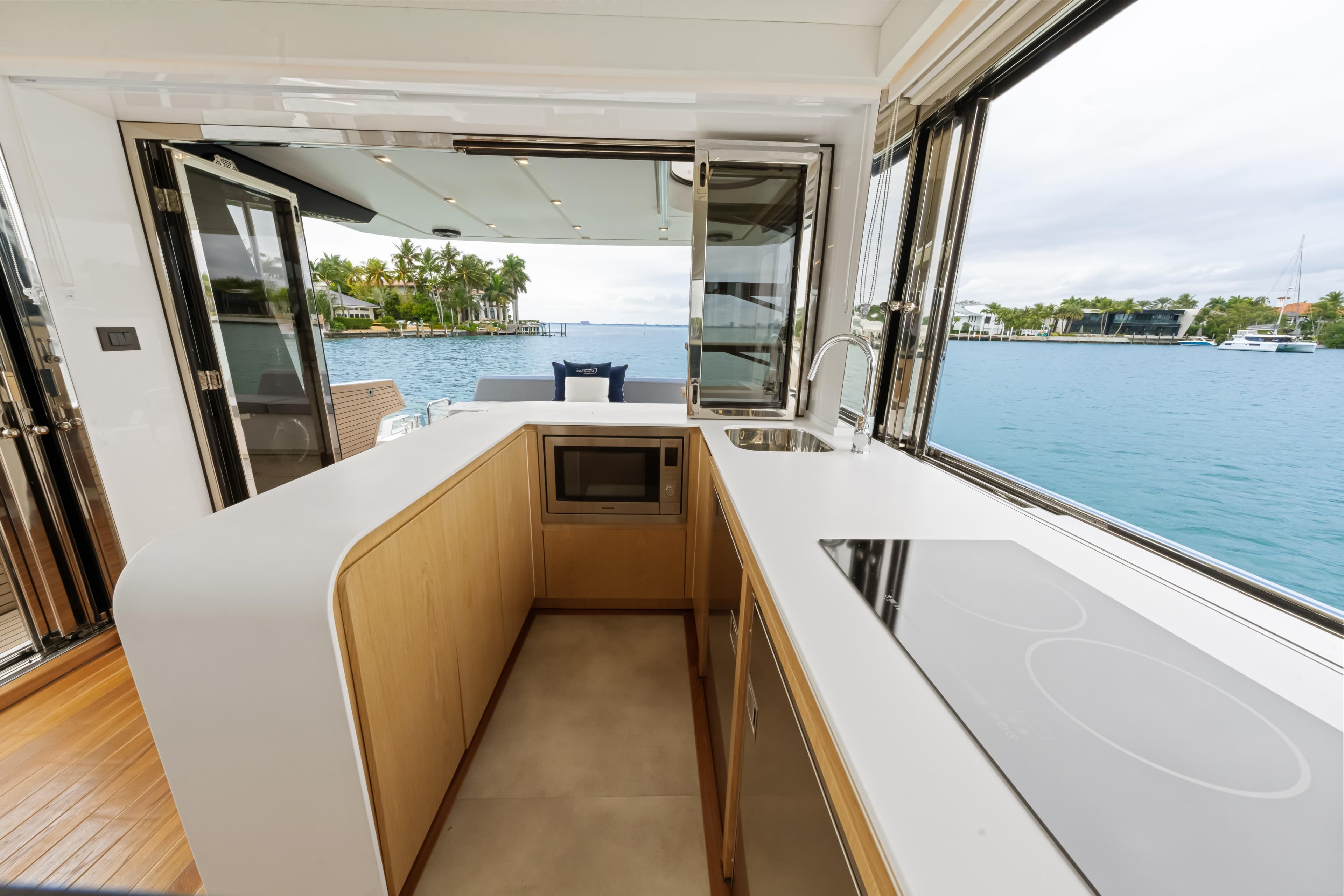 Modern kitchen on 2025 OKEAN 52 yacht with ocean view.