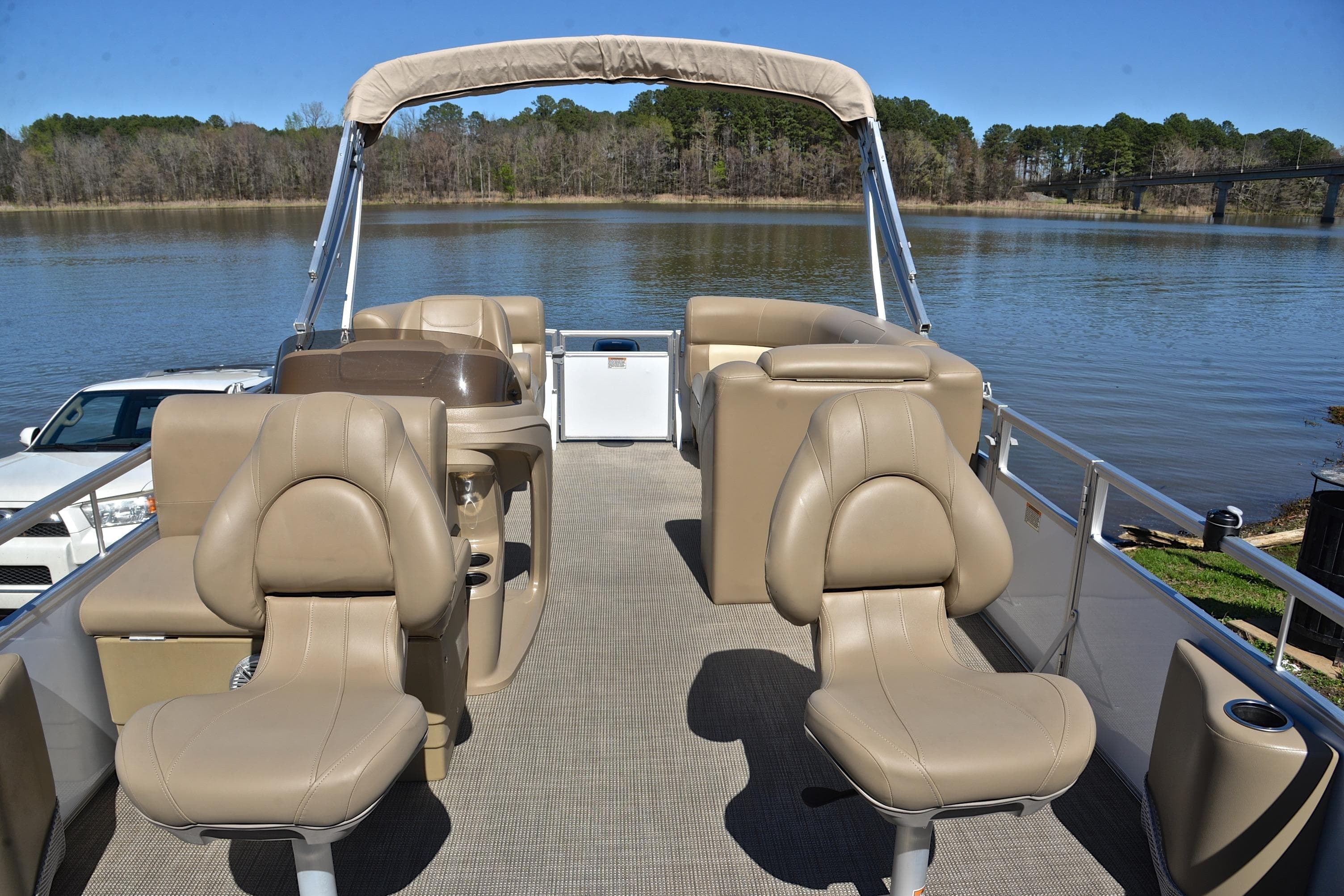 2023 Starcraft EX 18 F pontoon boat with beige seating on a calm lake.