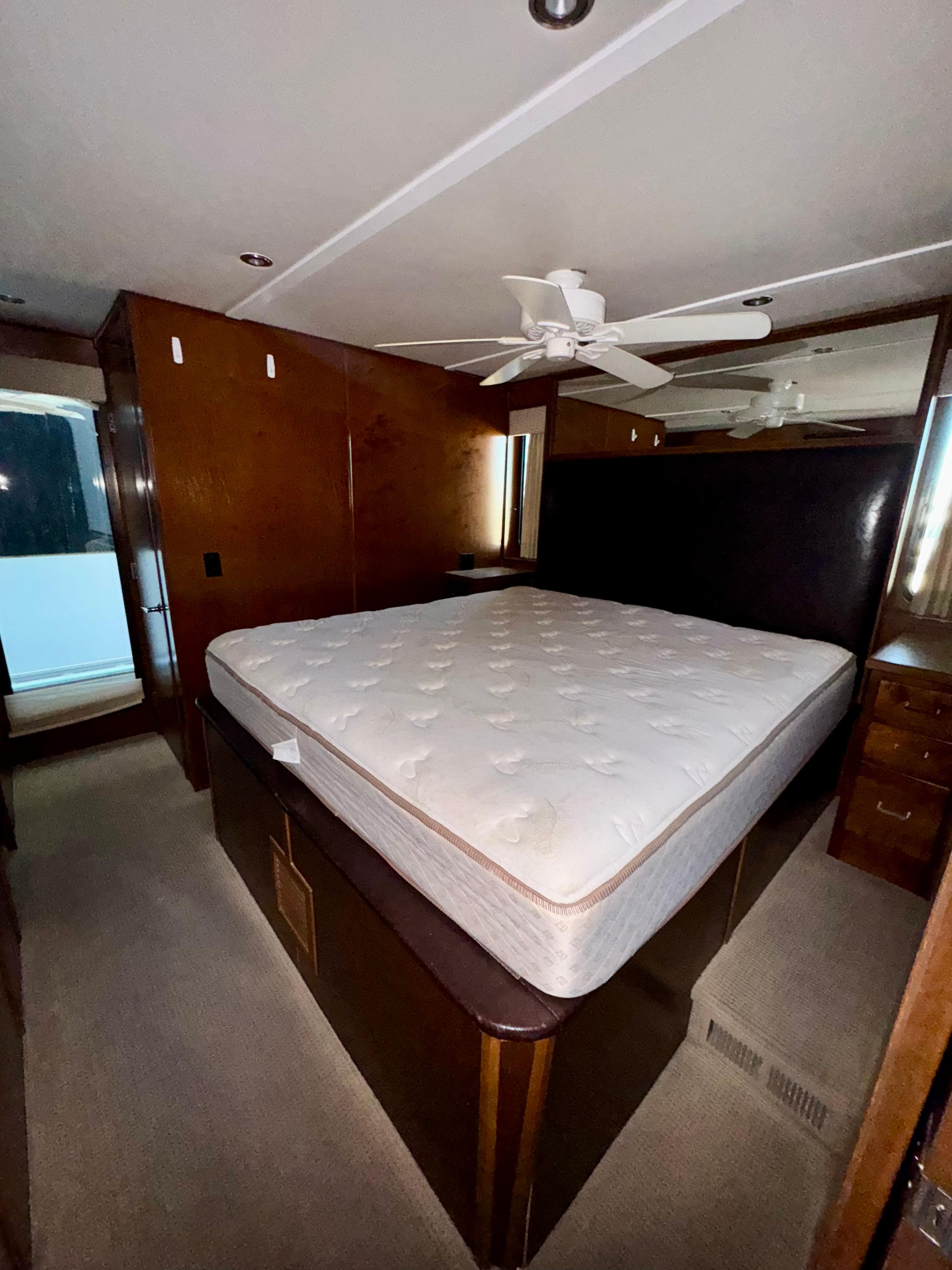 Bedroom interior of 2013 Bravada Bella Luna Trip #16 with bed and ceiling fan.